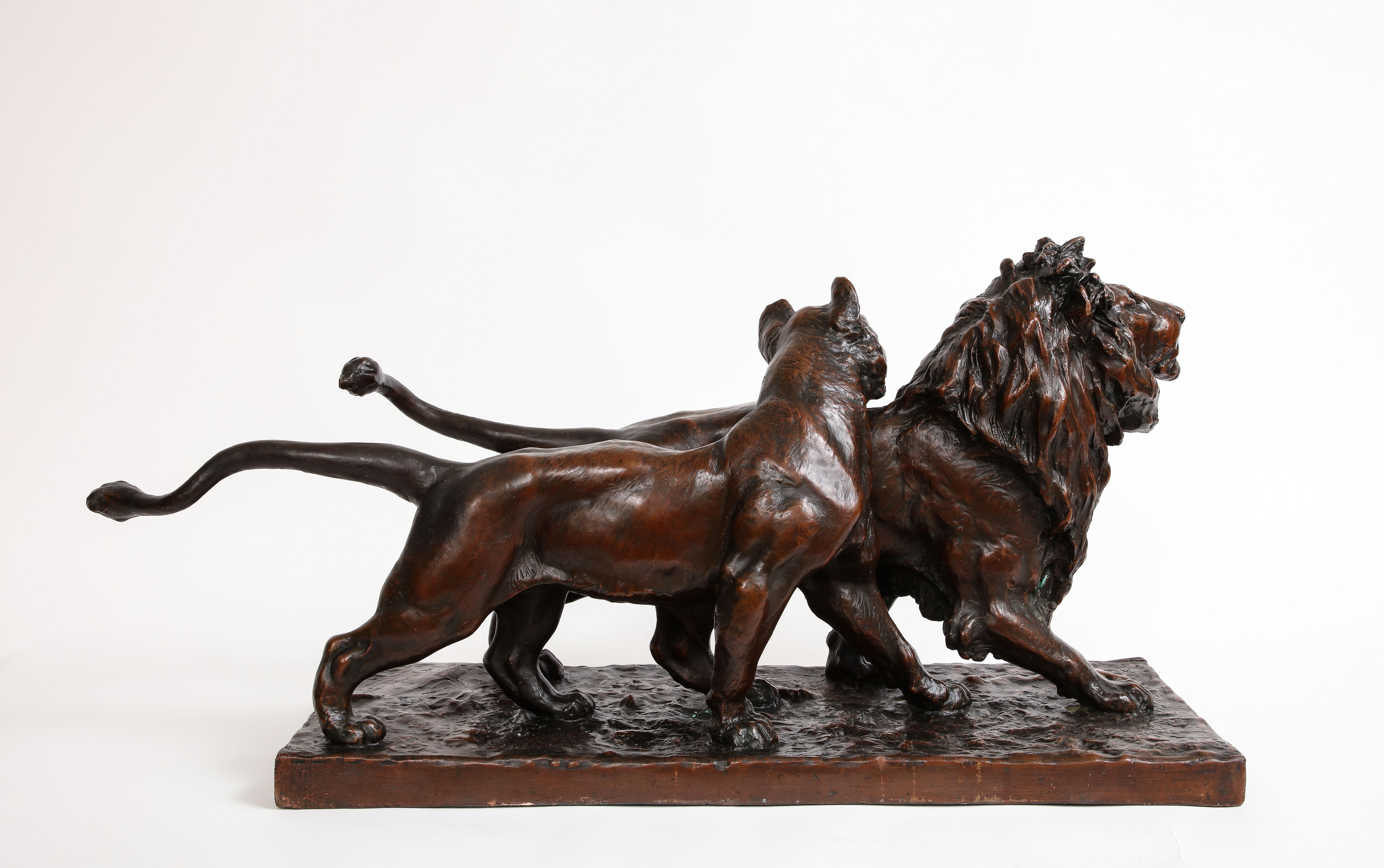 A Patinated Bronze Sculpture of Two Striding Lions, Signed By the Artist In Good Condition For Sale In New York, NY