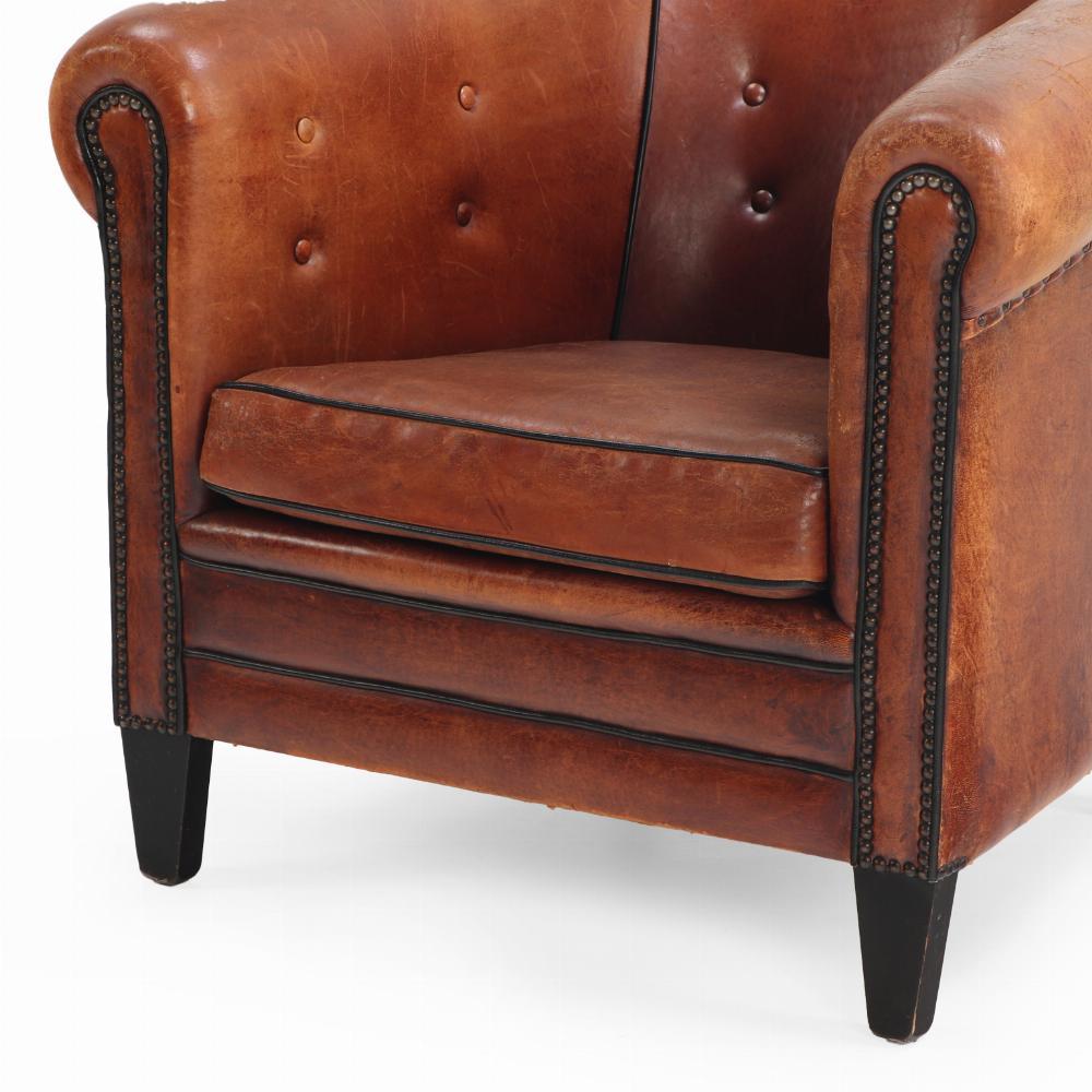 This tub style sheepskin leather club chair speaks luxury! With its tufted back, decorative nails and black trim, this chair has wonderful seating comfort and a timeless appearance. You can easily be place it in either a classic or a modern