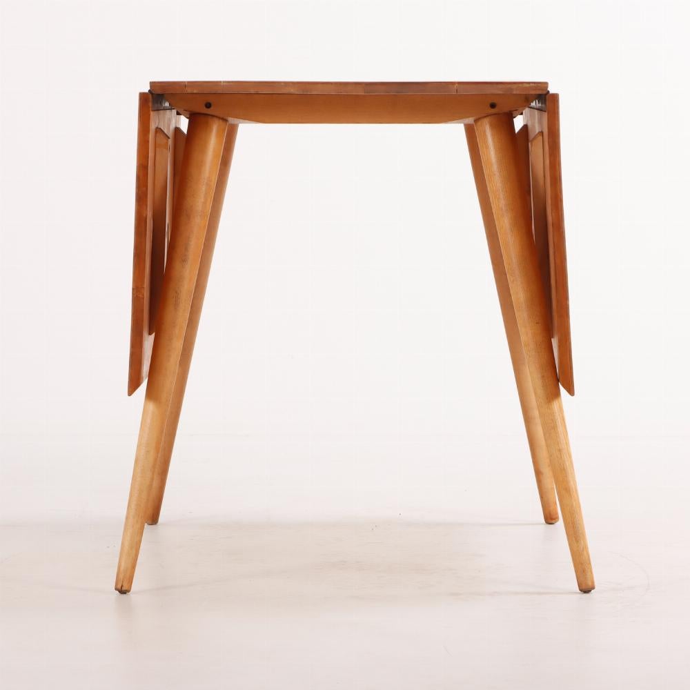 Mid-Century Modern A Paul McCobb (American, 1917-1969), maple drop leaf dining table circa 1950.