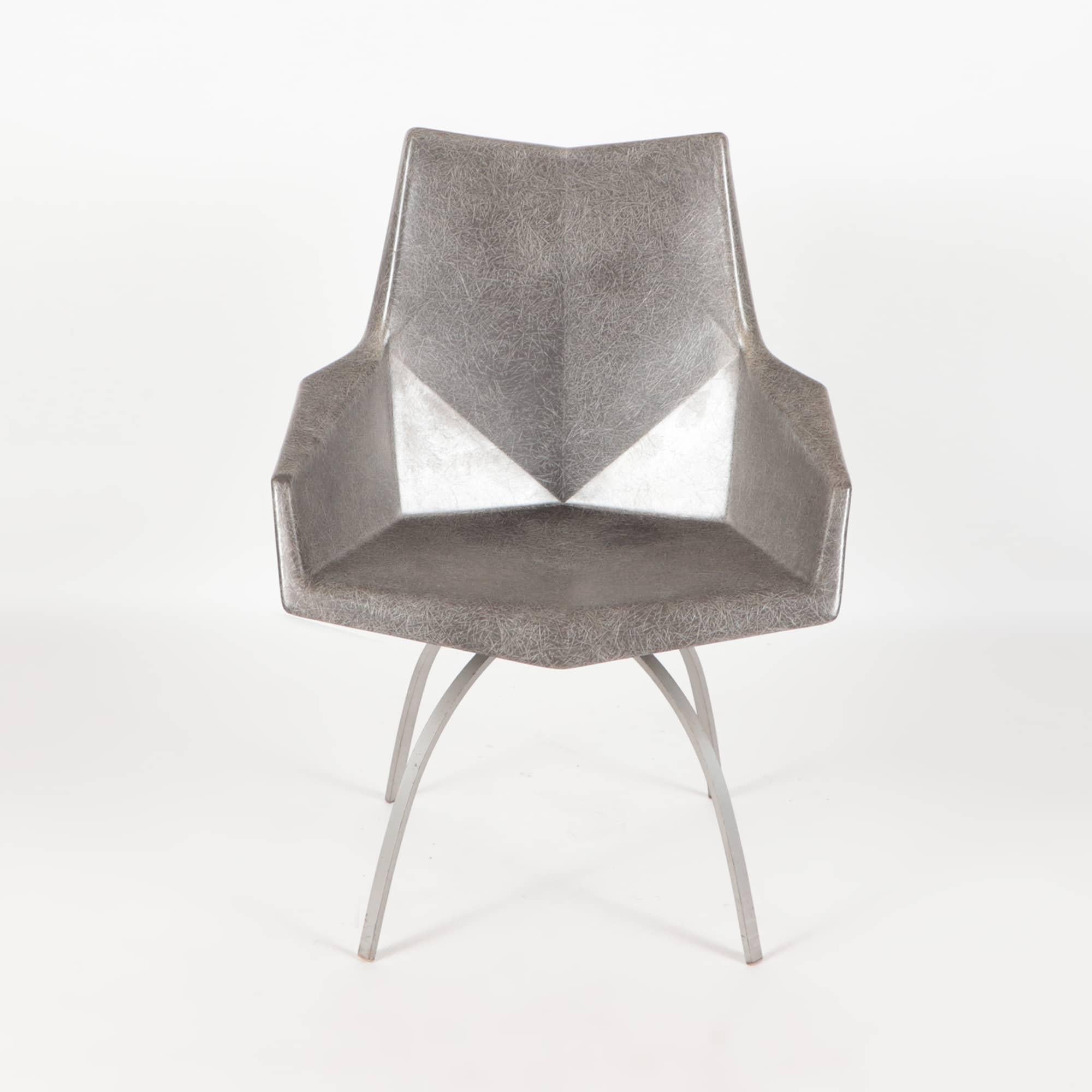 Designed in 1959 as the faceted form chair, Paul McCobb’s fiberglass seating has become known as the Origami Chair, its molded facets reminiscent of the Japanese art of paper folding. This one sits on a rarer spider base.