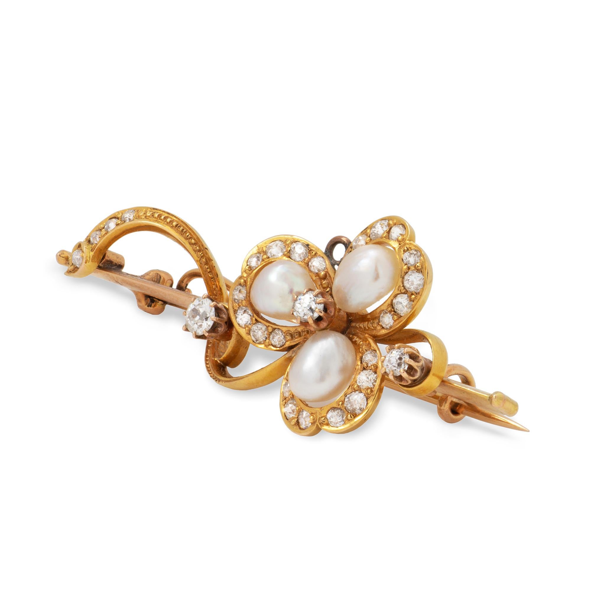 A Victorian pearl and diamond clover brooch, set with brilliant-cut diamond to the centre surrounded by three pearl set petals each within a diamond-set frame, to a stylized gold stem and further diamond decorations, measuring approximately 5.2 x