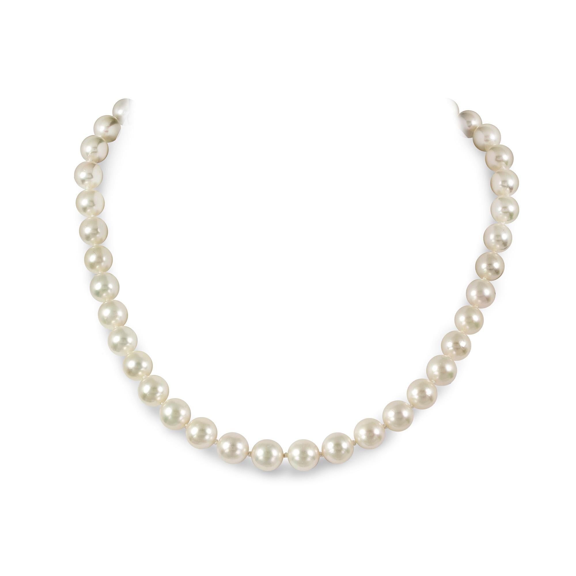 A pearl and diamond necklace, the necklace strung with 42 spherical cultured pearls measuring approximately 9.5-10 mm in diameter, with diamond-set filigree openwork barrel clasp, the round brilliant-cut diamonds all millegrain-set in 18 carat white