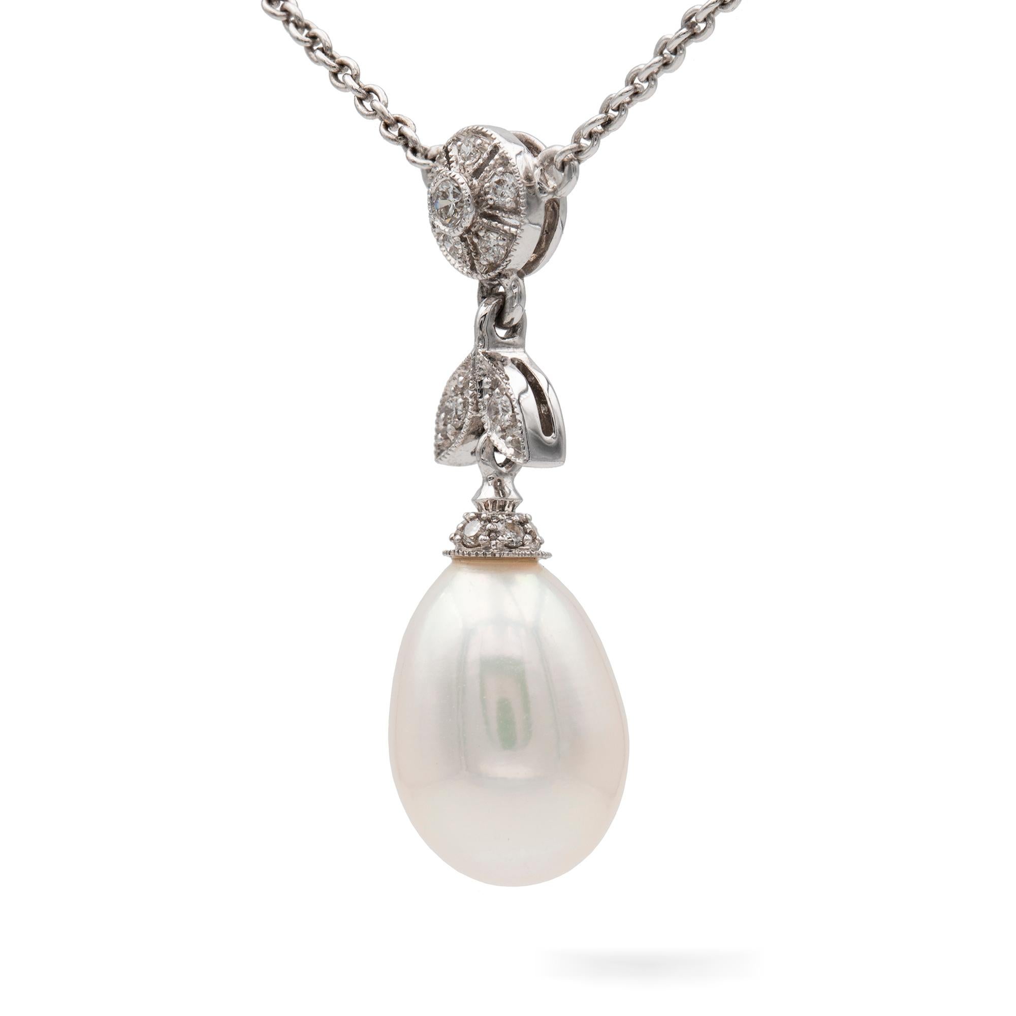 A pearl and diamond pendant/necklace, consisted of an oval-shaped pearl, with a diamond-set cap and diamond-set surmount of floral and foliate design, suspended by fine white gold trace chain set with six small round brilliant-cut diamonds, the
