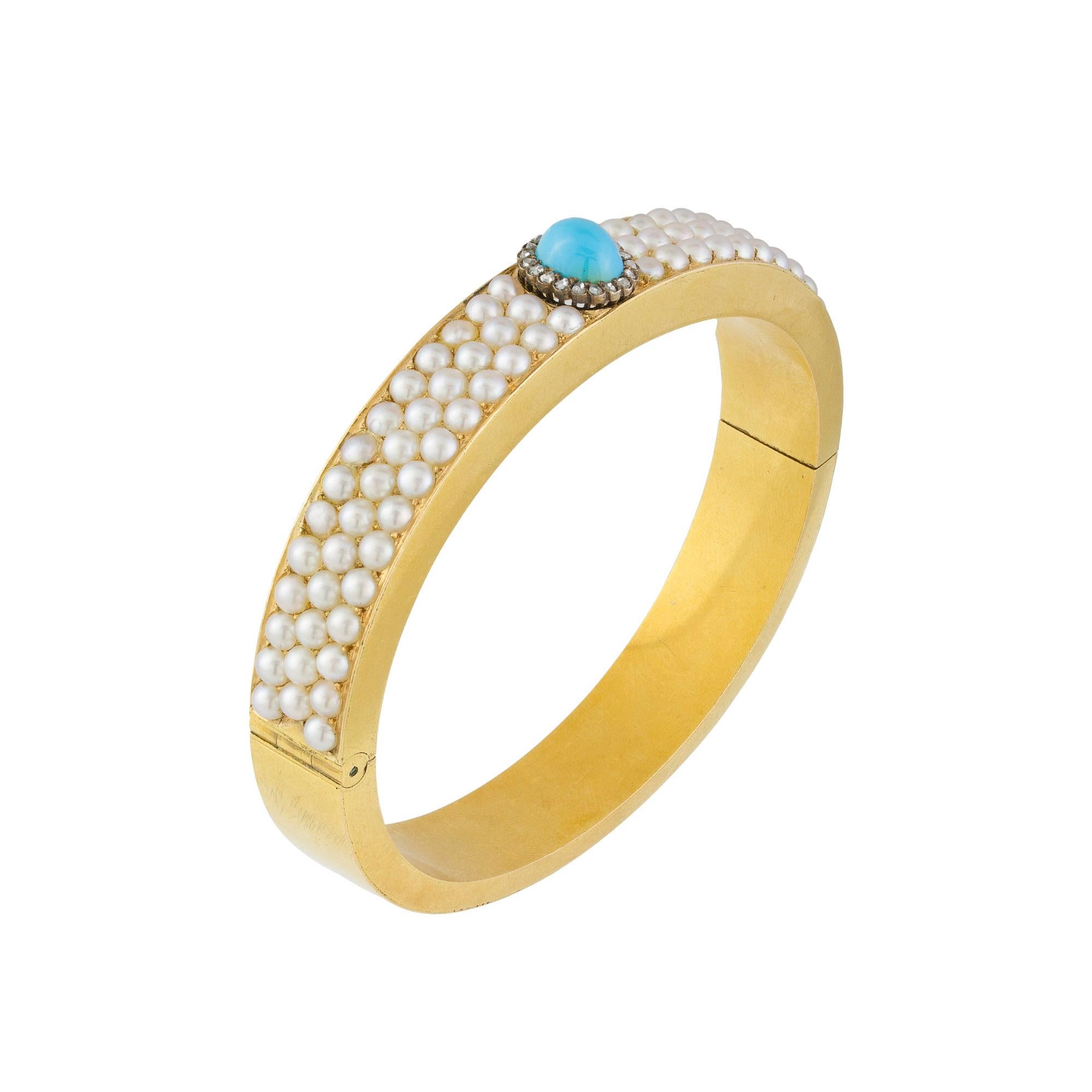 A Victorian pearl, turquoise and diamond bangle, the oval cabochon-cut turquoise surrounded by nineteen small rose-cut diamonds, set between three rows of natural split-pearls, all set to gold mount, circa 1880, measuring 6.9 x 1cm, gross weight 37
