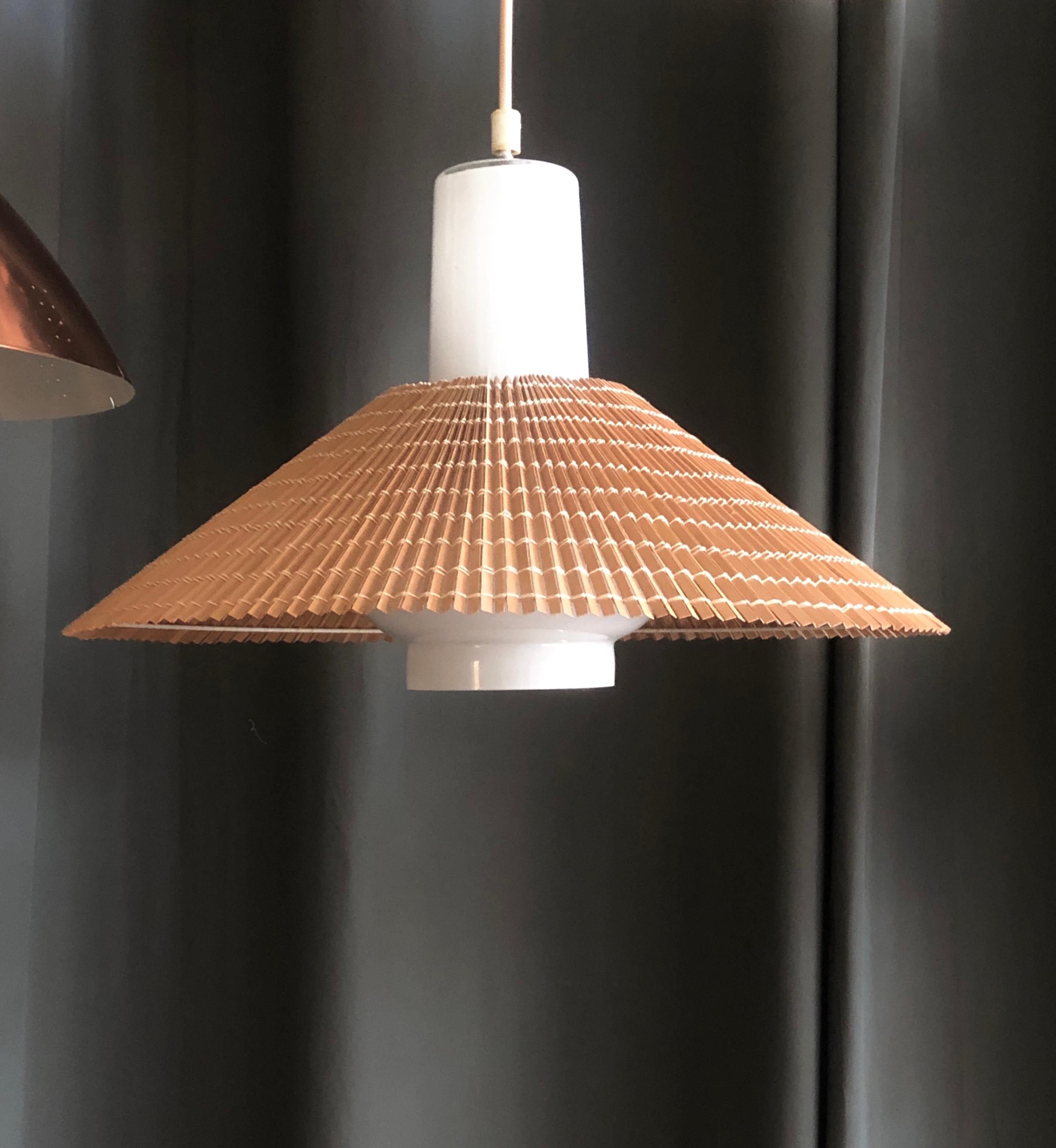 The pendant designed by Paavo Tynell for Idman, Finland , Circa 1950th.
Model K3-43, with rare lamellar wood shades.
Similar item featured at Idman catalog #142. p 75.
Rewiring as per customer specification available upon request.
2 items