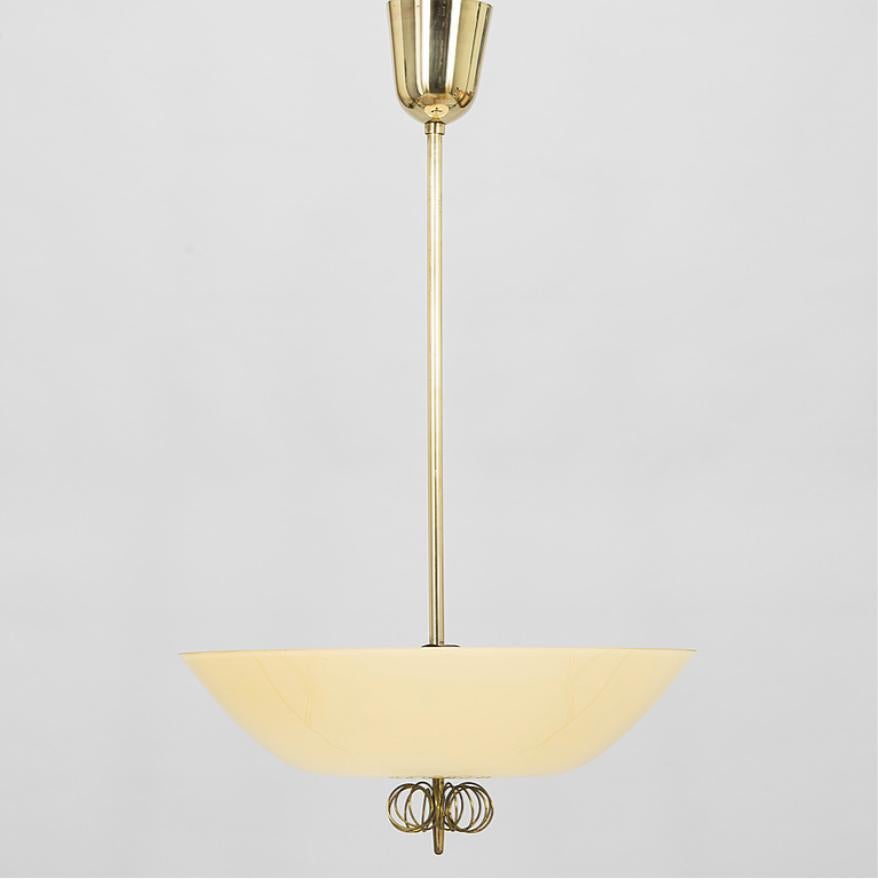 Hängeleuchte, entworfen von Paavo Tynell für Taito Oy, Modellnummer '1088'. Finnland, um 1950.

Schaft aus Messing, Schirm aus bernsteinfarbenem Glas. Gesamthöhe 29