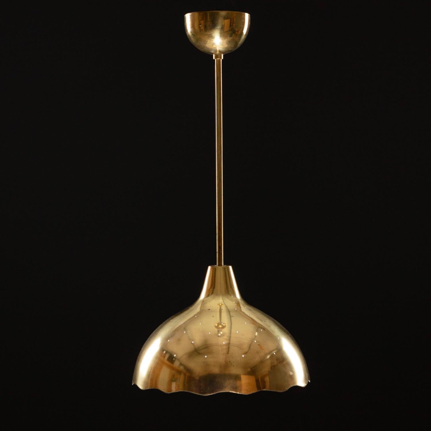 A pendant designed by Paavo Tynell for Idman, Model 51109.
Perforated brass. 
Rewiring available upon request.