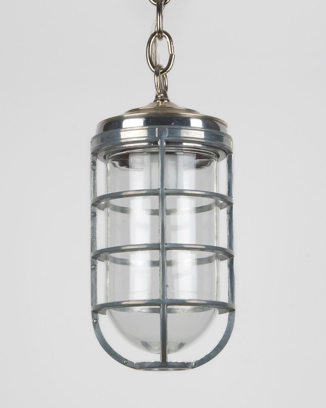 AHL3417
An aluminum cage pendant with a clear jelly jar glass lens. Suspended from polished nickel chain and fittings made in the Remains Lighting workshop.

Dimensions:
Current height: 40