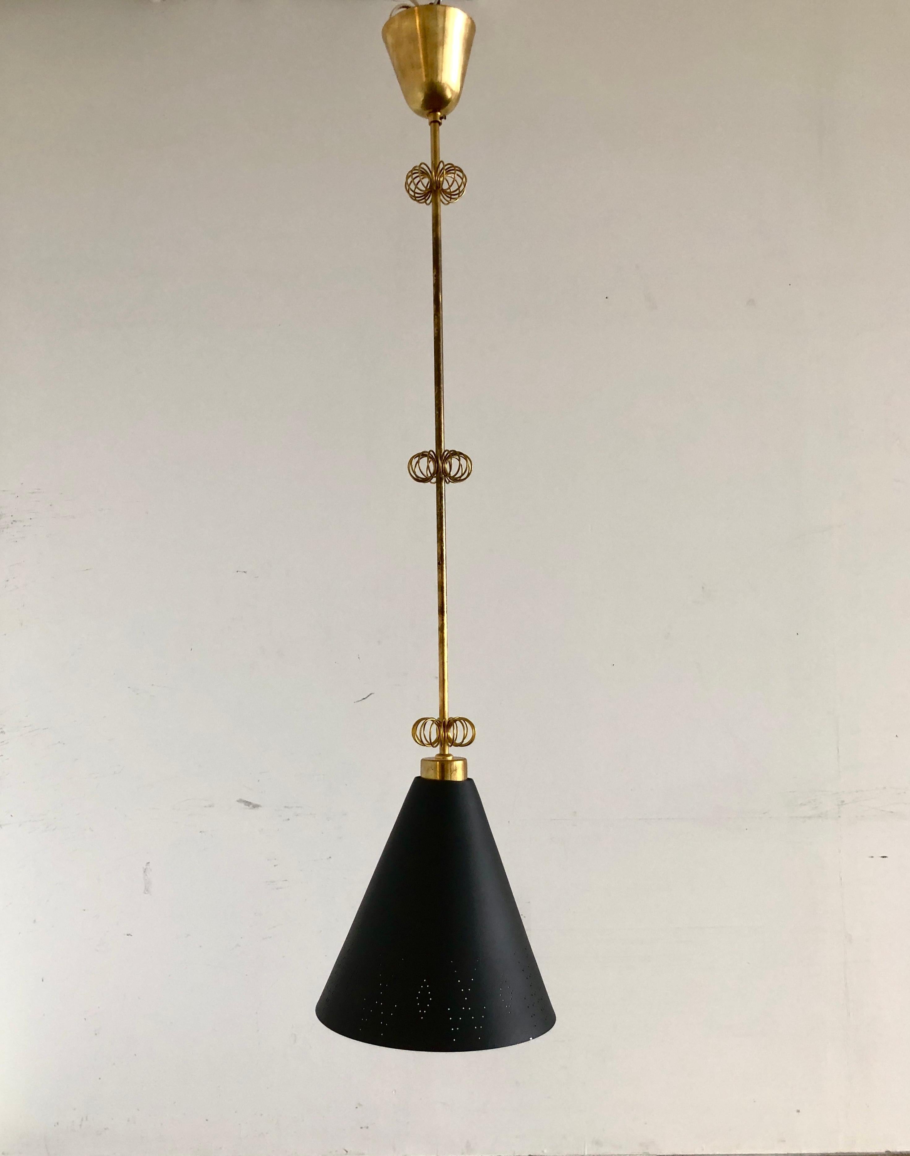 A Pendant designed by Paavo Tynell, produced by Idman Oy, Finland, circa 1950.
Perforated metal shade, polished brass stem with brass wire decorations.
Diameter 10