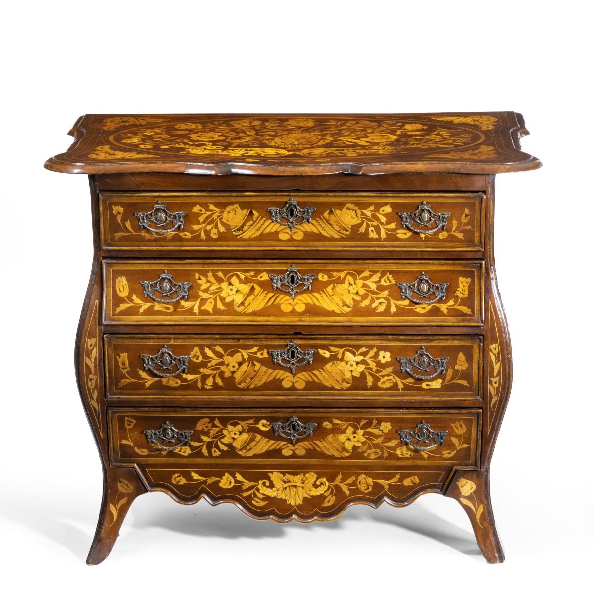 A period Dutch mahogany four-drawer bombe marquetry commode, the serpentine shaped top overhanging four graduated drawers, three with bombe front and sides, above a serpentine apron and splayed feet, profusely decorated throughout with variegated