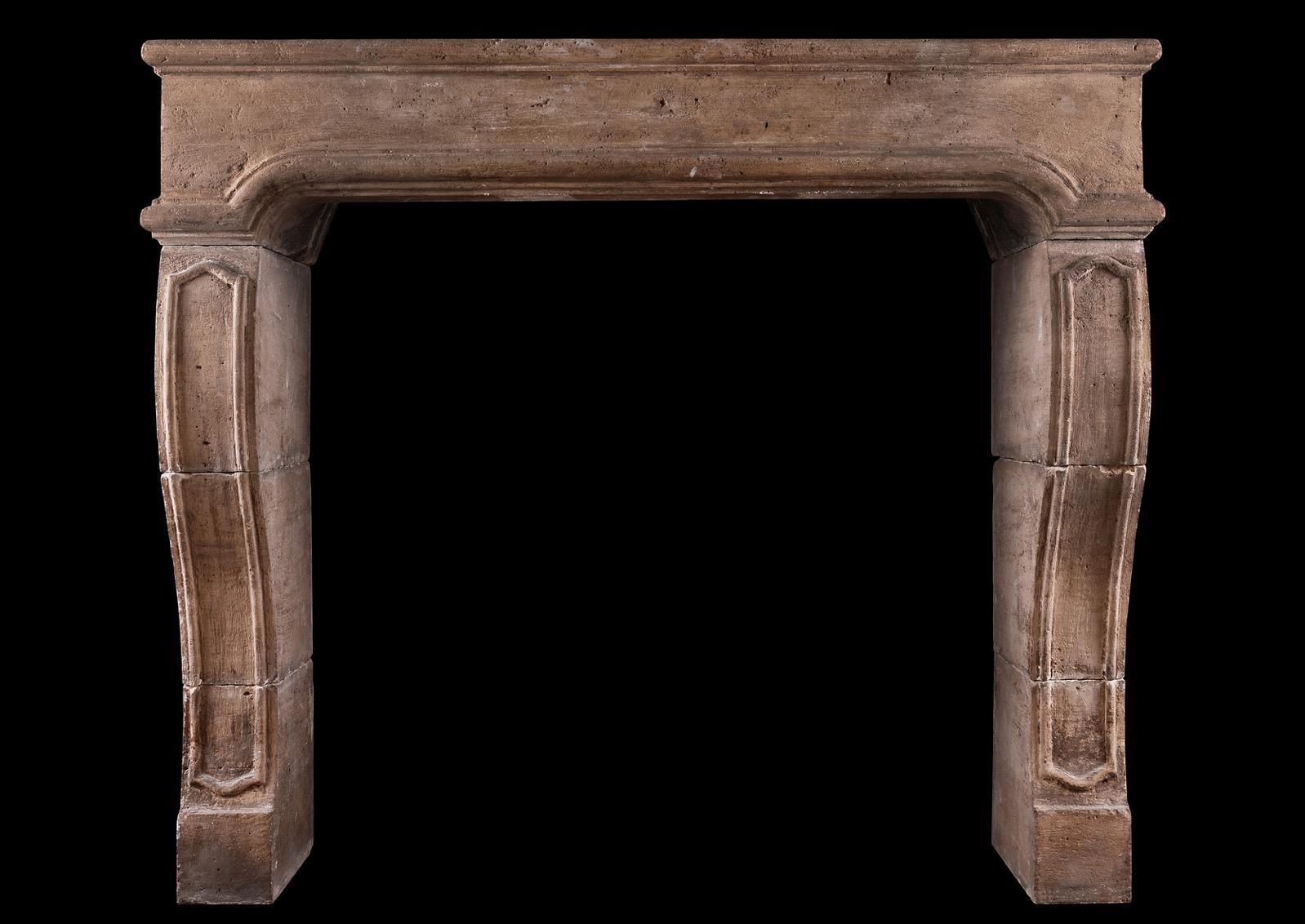A substantial French Louis XIV limestone fireplace. The shaped jambs with panelling to front, surmounted by arched frieze. Unusually tall for this style of fireplace. French, 18th century. 

Shelf Width:	1495 mm      	58 ⅞