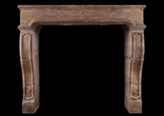 A Period French Louis XIV Limestone Fireplace