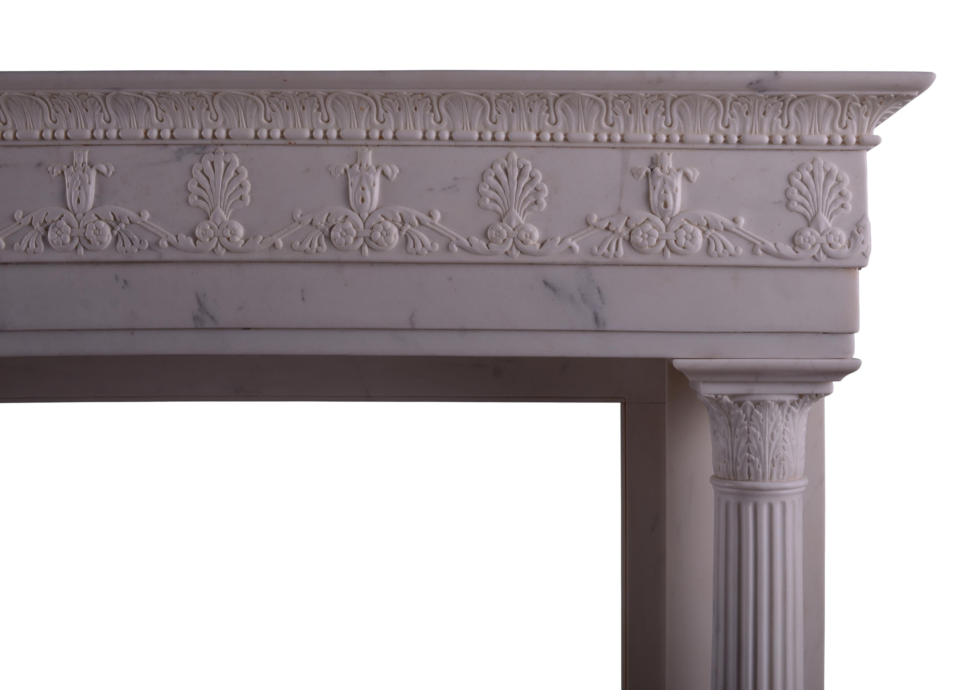A very fine quality period Regency statuary marble fireplace. The jambs with columns with stiff acanthus leaves to base surmounted by tapering flutes and matching acanthus to top. The frieze with classical Anthemion motif, scrollwork and paterae