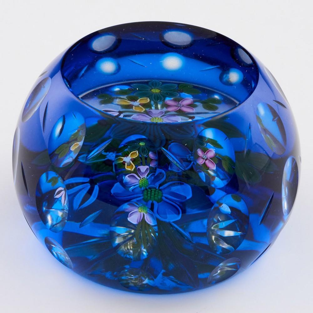 A Perthshire Bouquet Flash Overlay Paperweight, 1997

Additional information:
Date : 1997
Origin : Scotland
Features : A bouquet of four flowers, three buds and several leaves on a clear ground, all within a blue flash overlay. One top and thirty