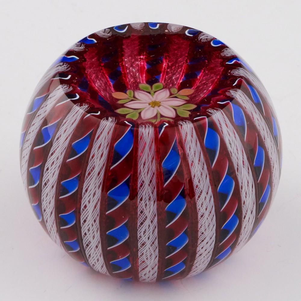 A Perthshire Crown Flower Overlayed Paperweight, 1996

Original Box. Signed and dated on the base.

Additional information:
Date : 1996
Origin : Scotland
Features : Red and blue twists alternating with white latticino rods over a ruby layer. A top