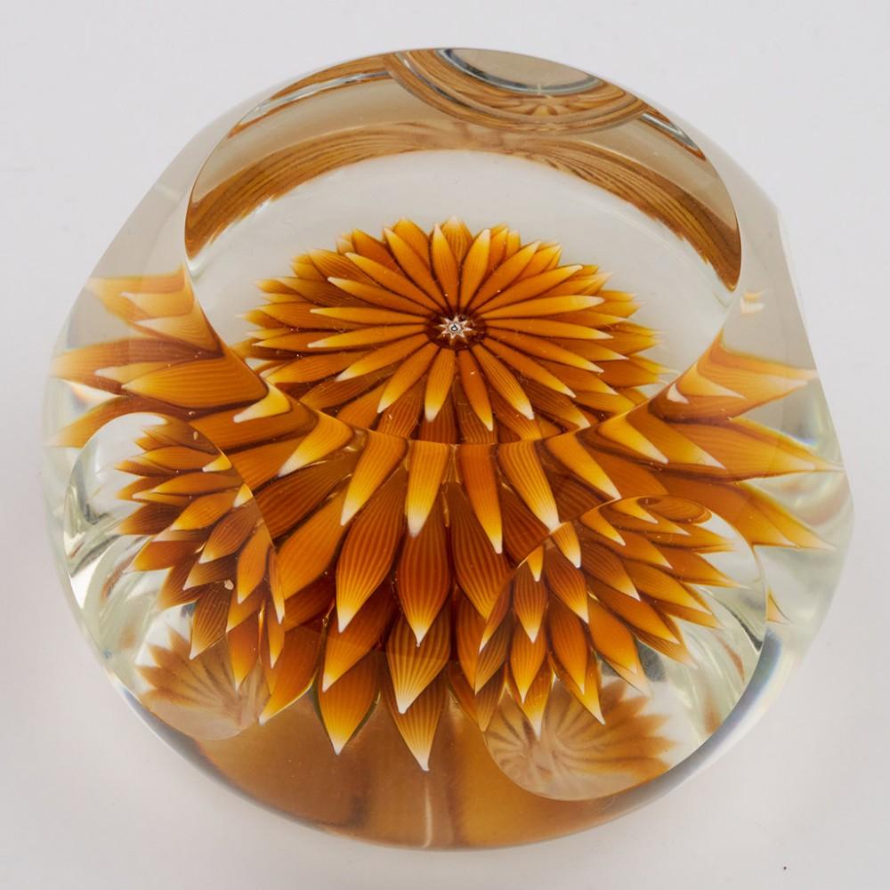 A Perthshire Golden Dahlia Paperweight, 1986

Additional information:
Date : 1986
Origin : Scotland
Features : Four layers of amber petals forming a large upright Dahlia blossom. Top facet and five side  windows
Marks : A central P cane at centre of