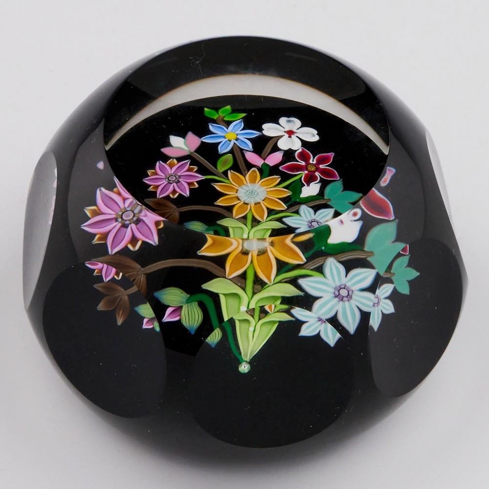 A Perthshire Lampwork Bouquet Paperweight, 1990

Additional information:
Date : 1990
Origin : Scotland
Features : A multicoloured lampwork bouquet with six flowers and several buds on a black ground. Faceted.
Marks : P cane to the base of the