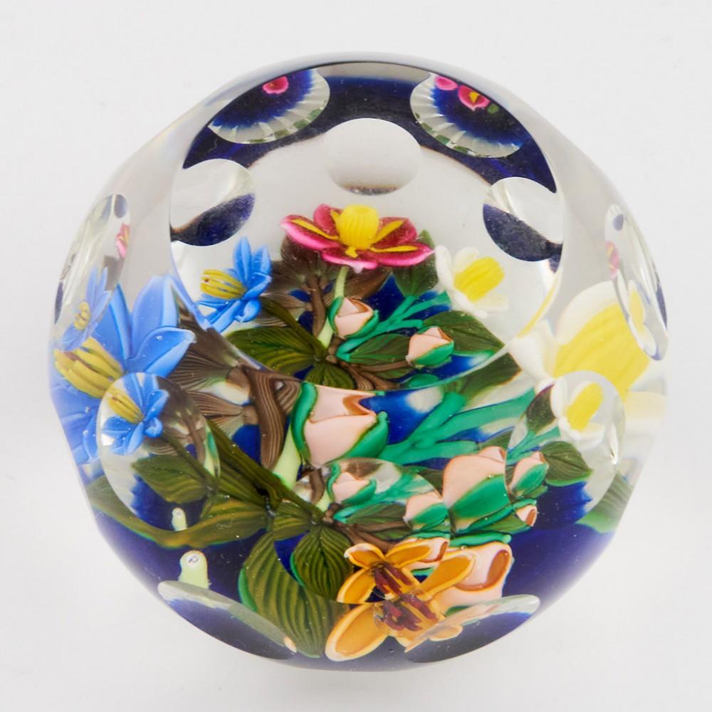 A Perthshire Lampwork Three Dimensional Bouquet Paperweight, 1993

Original Box.

Additional information:
Date : 1993
Origin : Scotland
Features : A three dimensional bouquet of four lampwork flowers and three buds above a blue flash with top facet