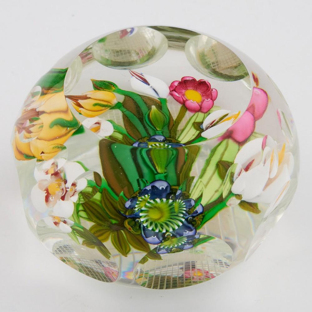 A Perthshire Large Bouquet Paperweight, 1990

Additional information:
Date : 1990
Origin : Scotland
Features : A three dimensional bouquet of six flowers and two buds on a cleat ground. Faceted.A P signature cane at the base of the stems
Marks : P