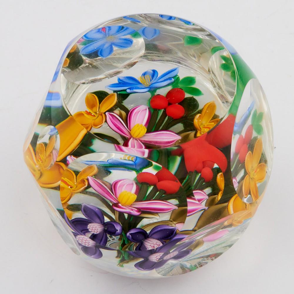 A Perthshire Three Dimensional Bouquet Paperweight, 1999 Additional information: Date : 1999 Origin : Scotland Features : A large bouquet of blue, pink, amber and amethyst flowers and buds on a clear ground with a feather cut base.One top facet,