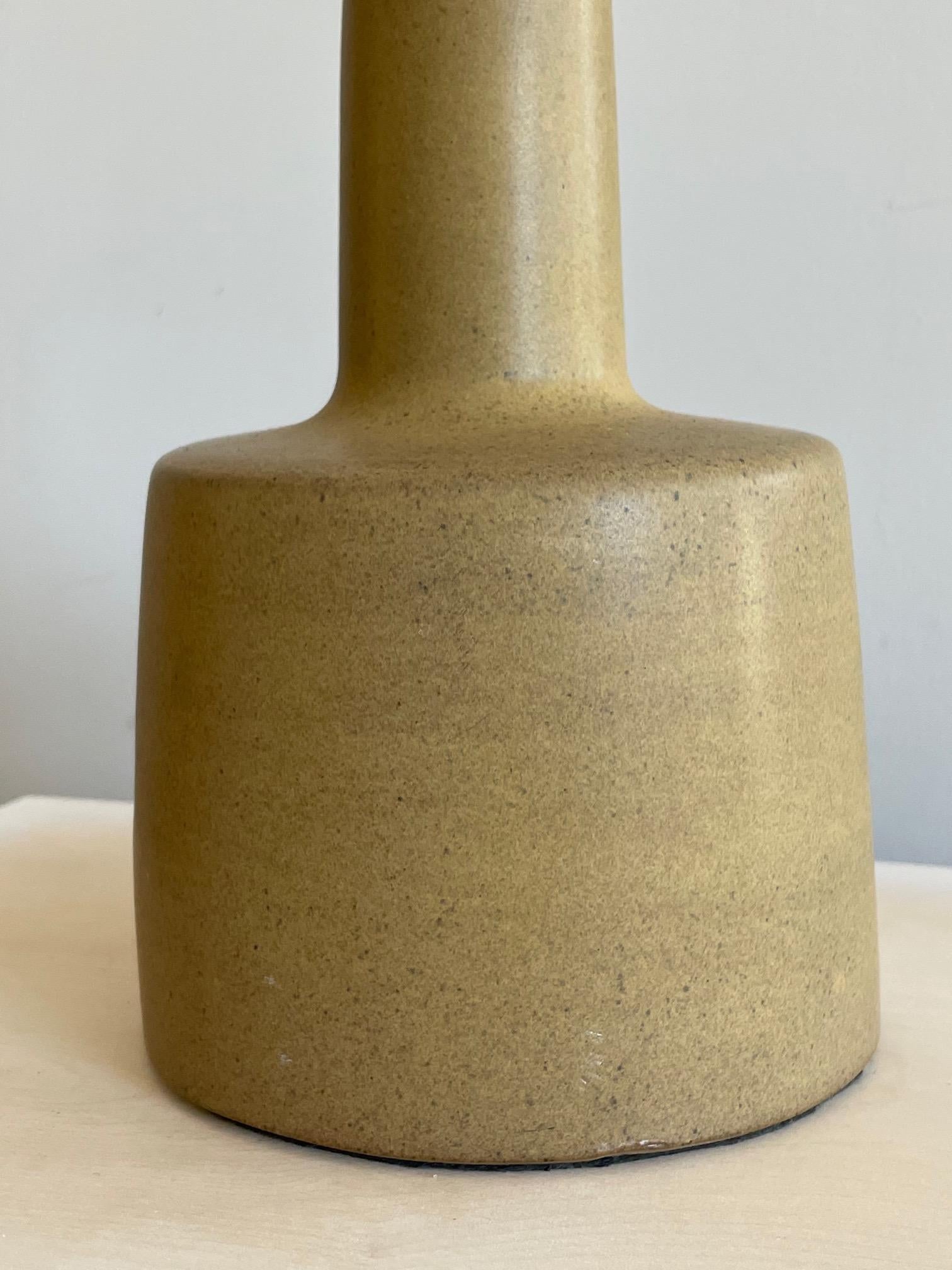 A classic petite lamp by Gordon and Jane Martz for Marshall Studios ca' 1960's. Mustard/earthy tone color with a satin glaze, the form is simple and sculptural. The lamp measures approx. 6