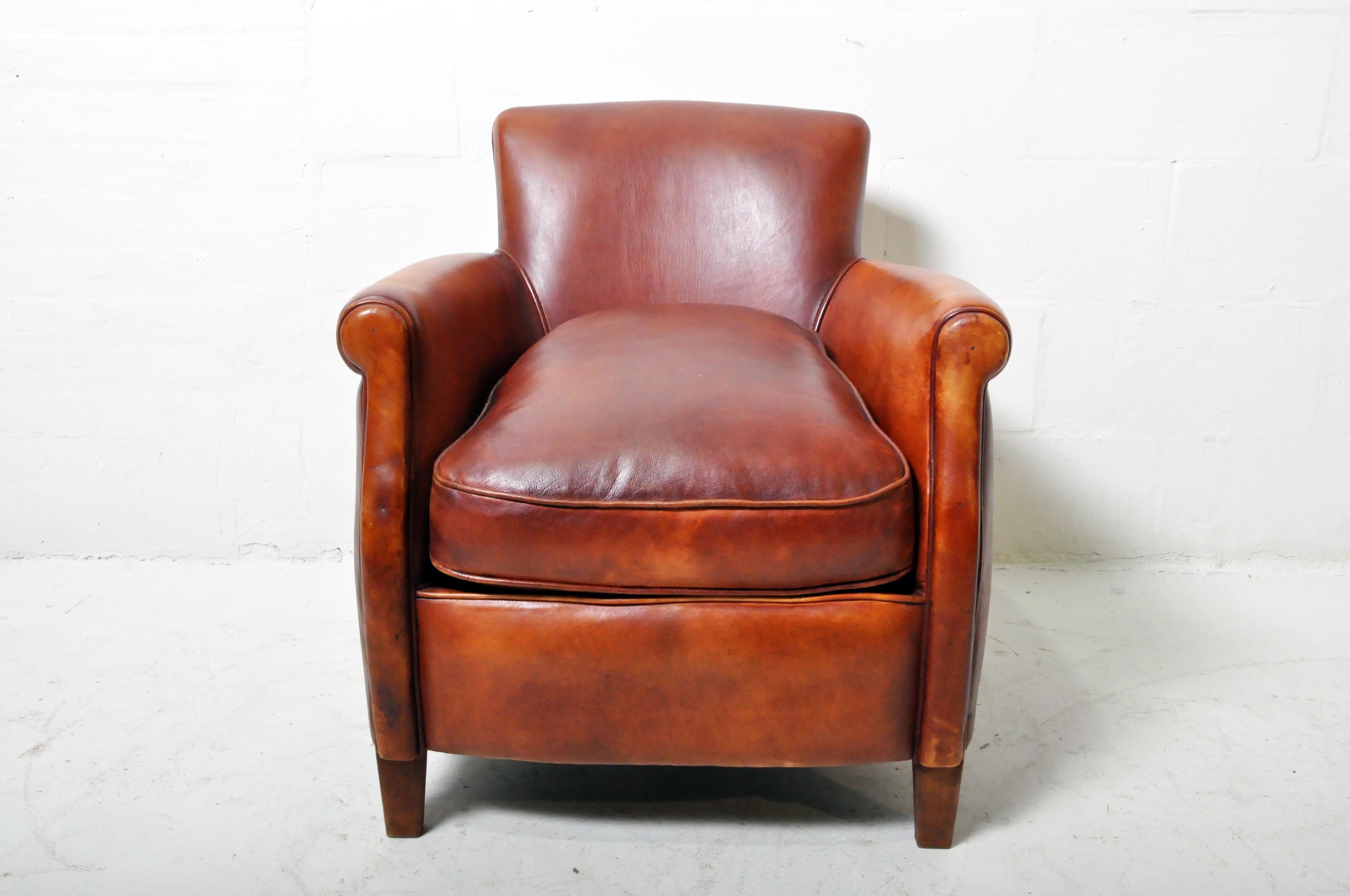A petite French leather club chair in sheep skin. The design is Art Deco and is closely based on 1930's French classic designs.