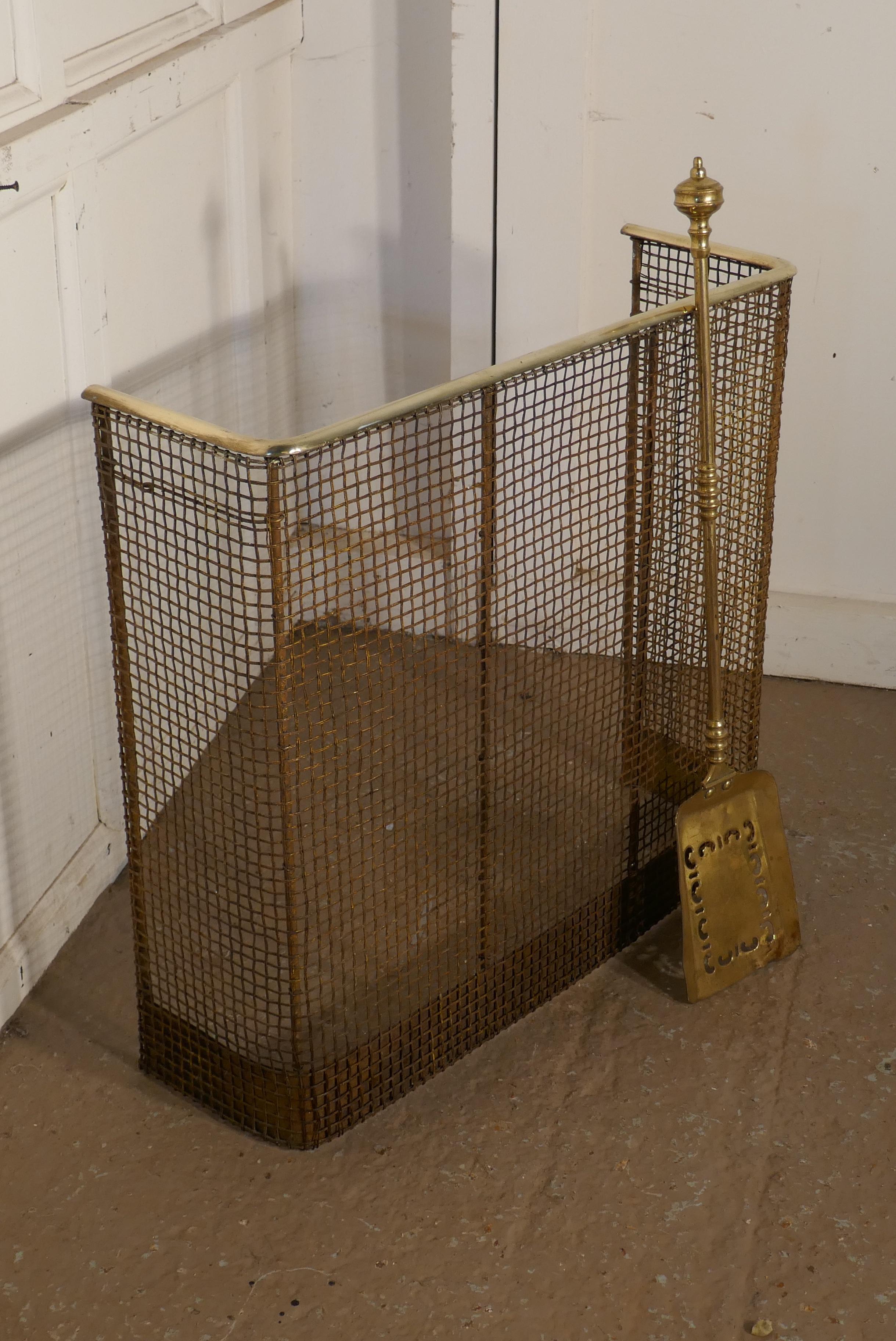 A petite high Victorian nursery fire guard, brass fender. 

A early Victorian antique fire guard often known as a nursery guard as it completely surrounds the fire, this one come with its long handled brass shovel
The fender has a slightly curved
