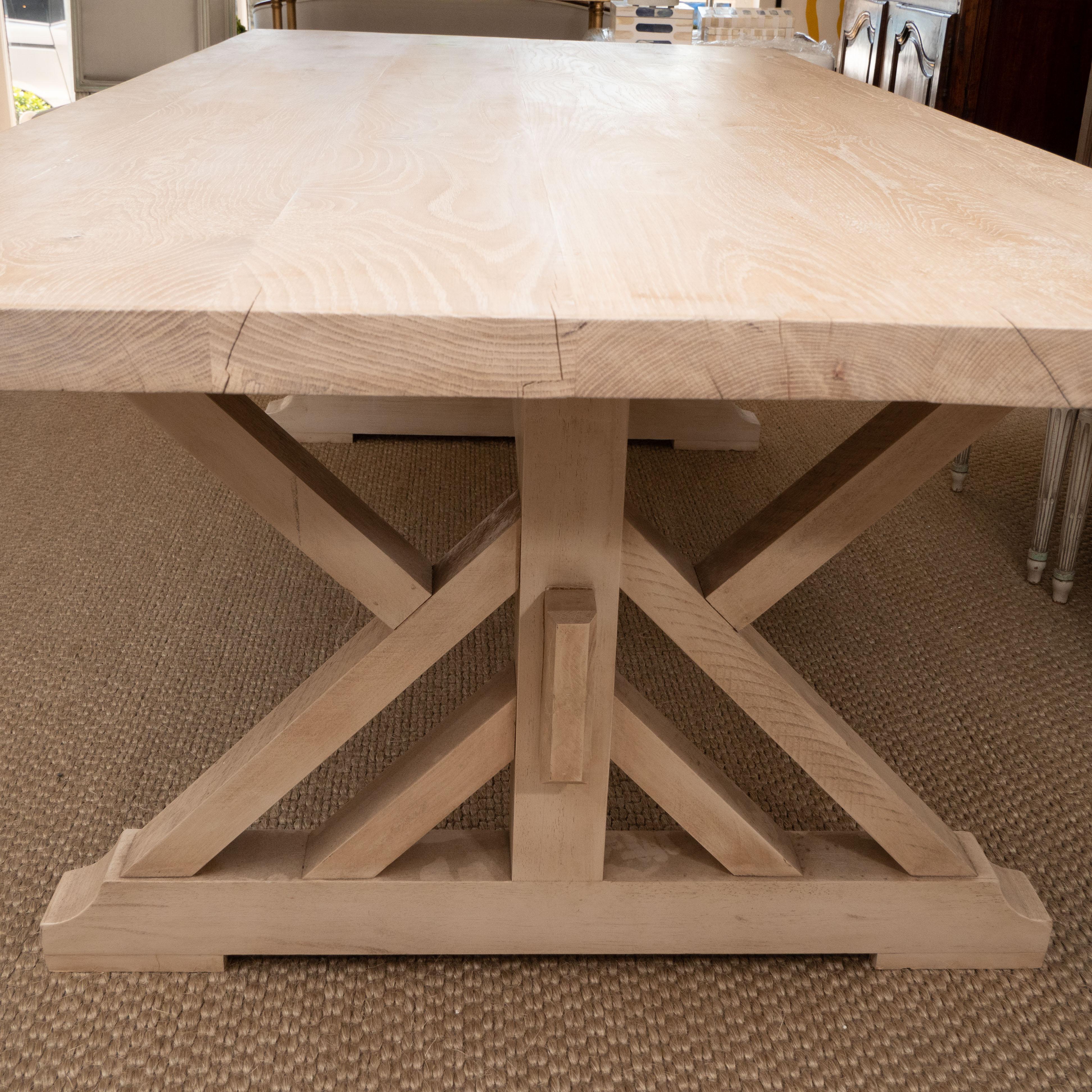 This farm table in a pickled pine with a trestle base has both form and function. Perfect for a big kitchen or dining room (or even in an office as a conference table), this seats comfortably seats 8 to 10.