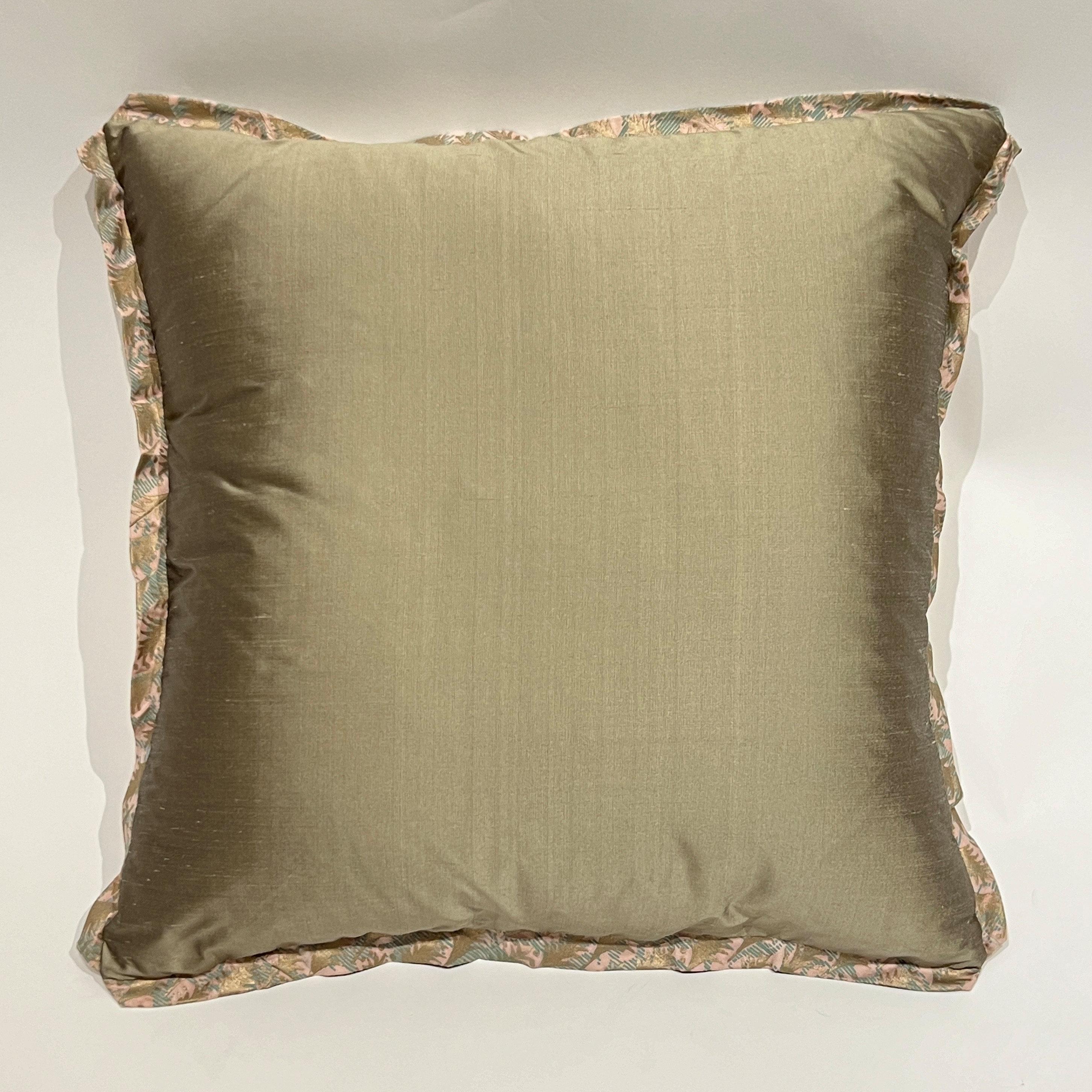 A pair of pieced and mitered Fortuny cushions in the Puimette pattern, in a pink, aquamarine and gold colorway. With self fabric bias edging, and the original Fortuny Puimette border on all sides.