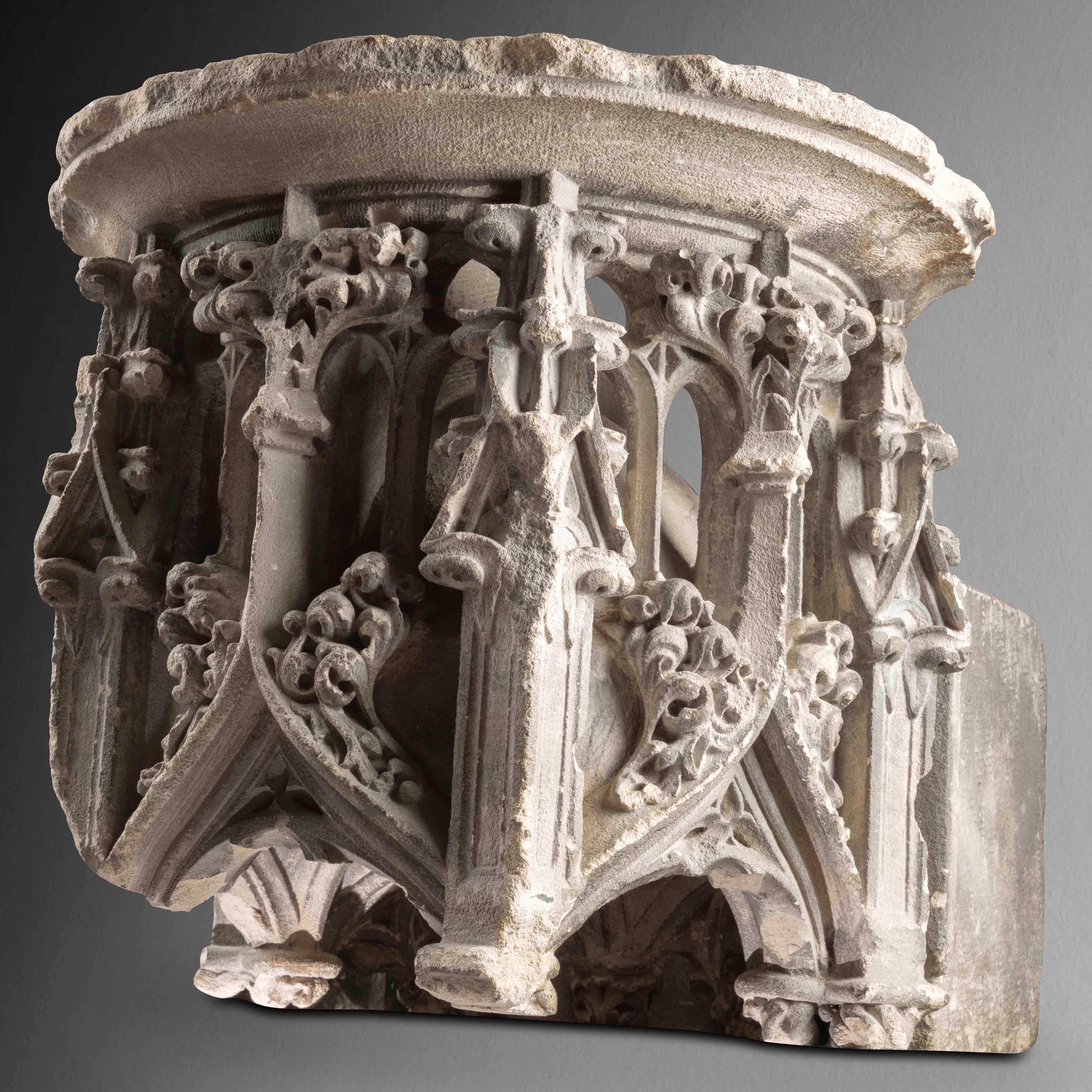 A pierced Flamboyant canopy
North of France, 15th century
Limestone
30 x 32 x 35 cm


This richly decorated canopy of circular plan, consist of three carved faces, each dominated by a cusped arch surmounted by curly cabbage, crockets and foliated