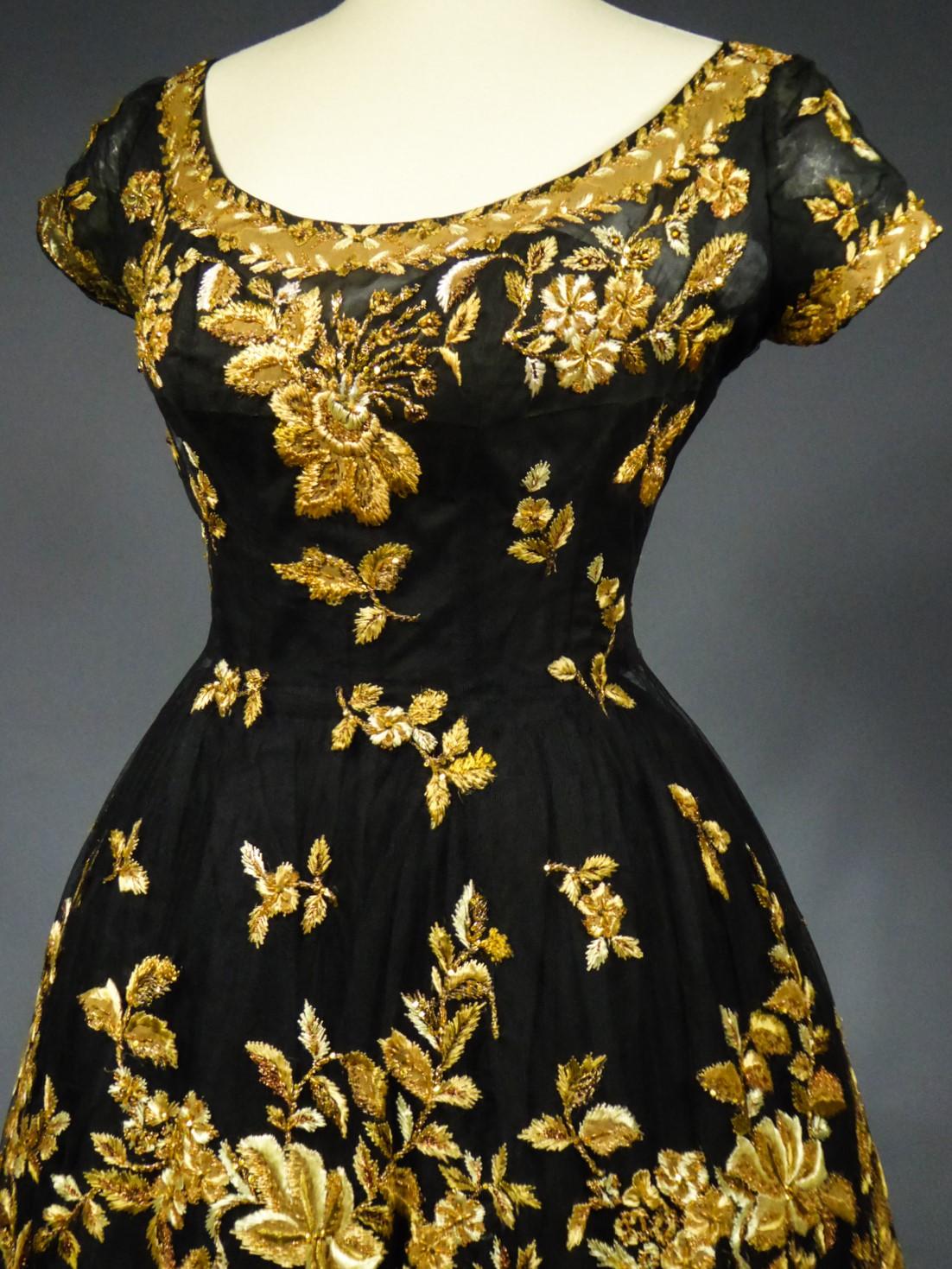 Circa 1958-1963

France

Haute Couture Cocktail Dress by Pierre Balmain from the wardrobe of Mrs Augier, owner of the Palace Negresco in Nice on the French Riviera. Babydoll type dress in black silk tulle densely embroidered with bouquets of flowers