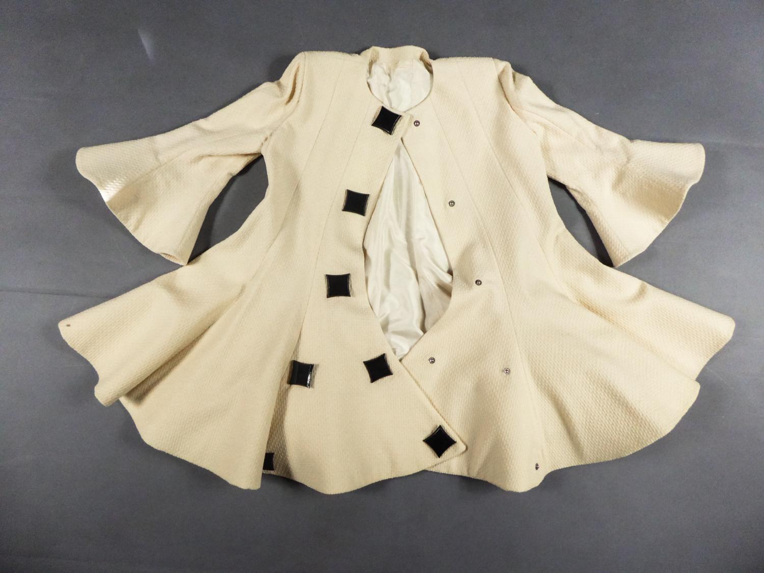 Circa 1990
France

Astonishing mid-length coat in embossed fashioned cream wool inspired by a skater cut by Pierre Cardin Haute Couture and dating from the 1990s. Cut with flared sleeves and bottom of the coat in corolla, stiffened by a tab in the