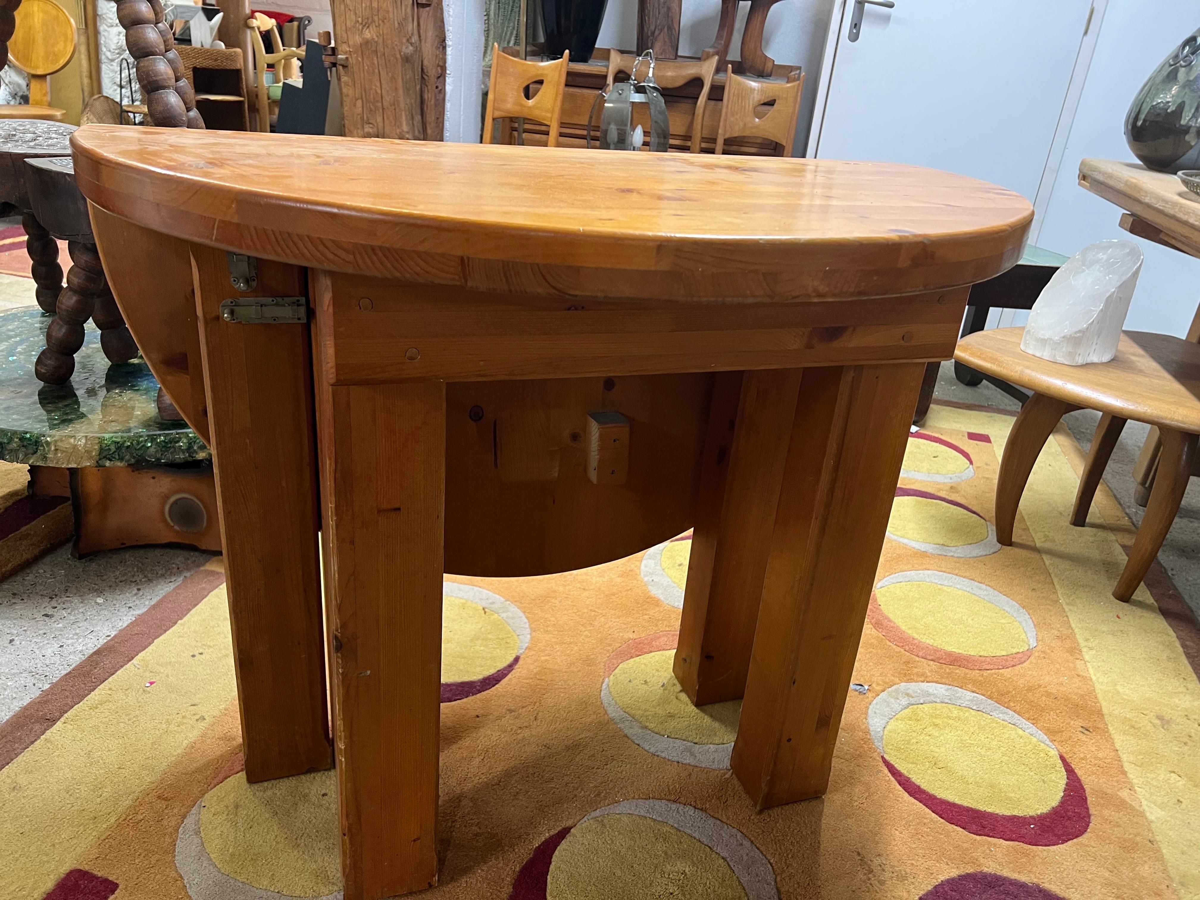 A round table, can also be a console in Pine made for les Arcs.