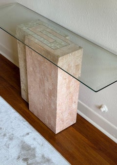 A pink fossil stone console table with glass top by Magnussen, circa 1980