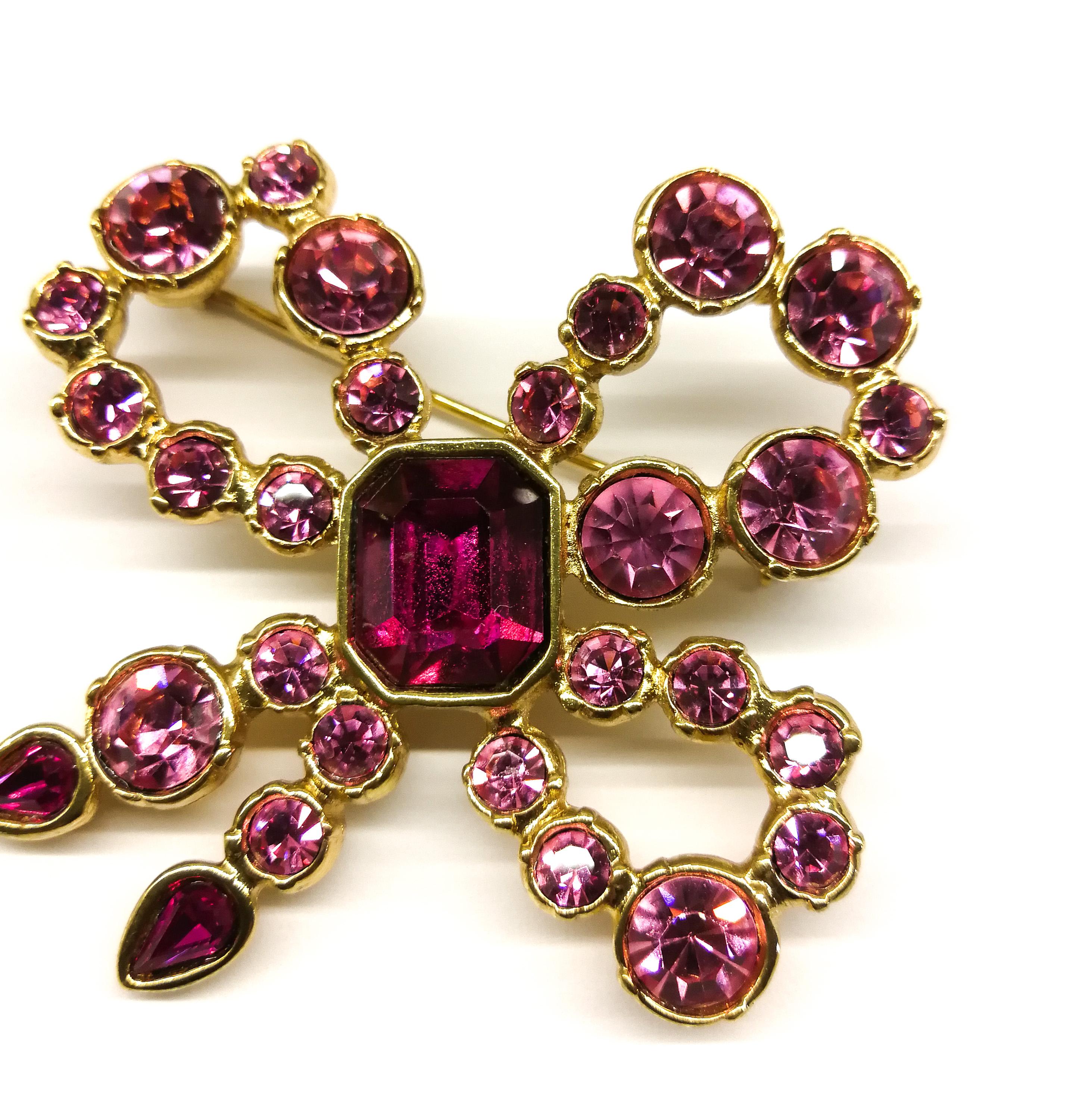 A pink paste and gilt metal 'bow' brooch, Yves Saint Laurent, France, 1980s In Excellent Condition In Greyabbey, County Down