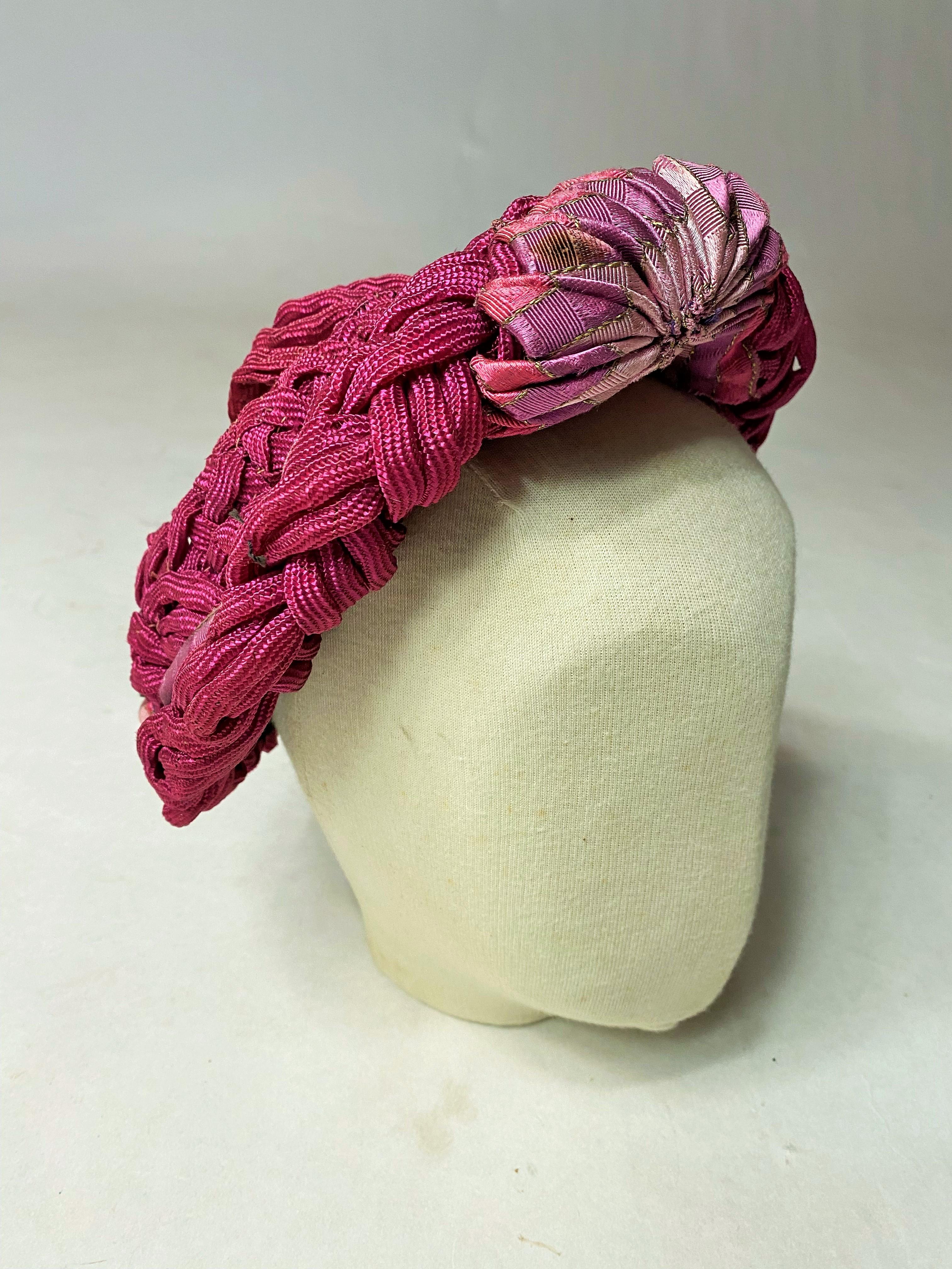Circa 1940-1945

France

Amazing lady's bibi made of cylindrical ribbon braids in Rafia and pink-parma Celluloid. Work done during the material shortage and made from recycled and recovered elements, from a seamstress probably at home! Matching