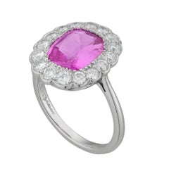 A pink sapphire and diamond cluster ring