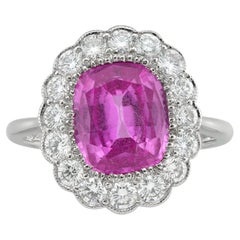 A pink sapphire and diamond cluster ring
