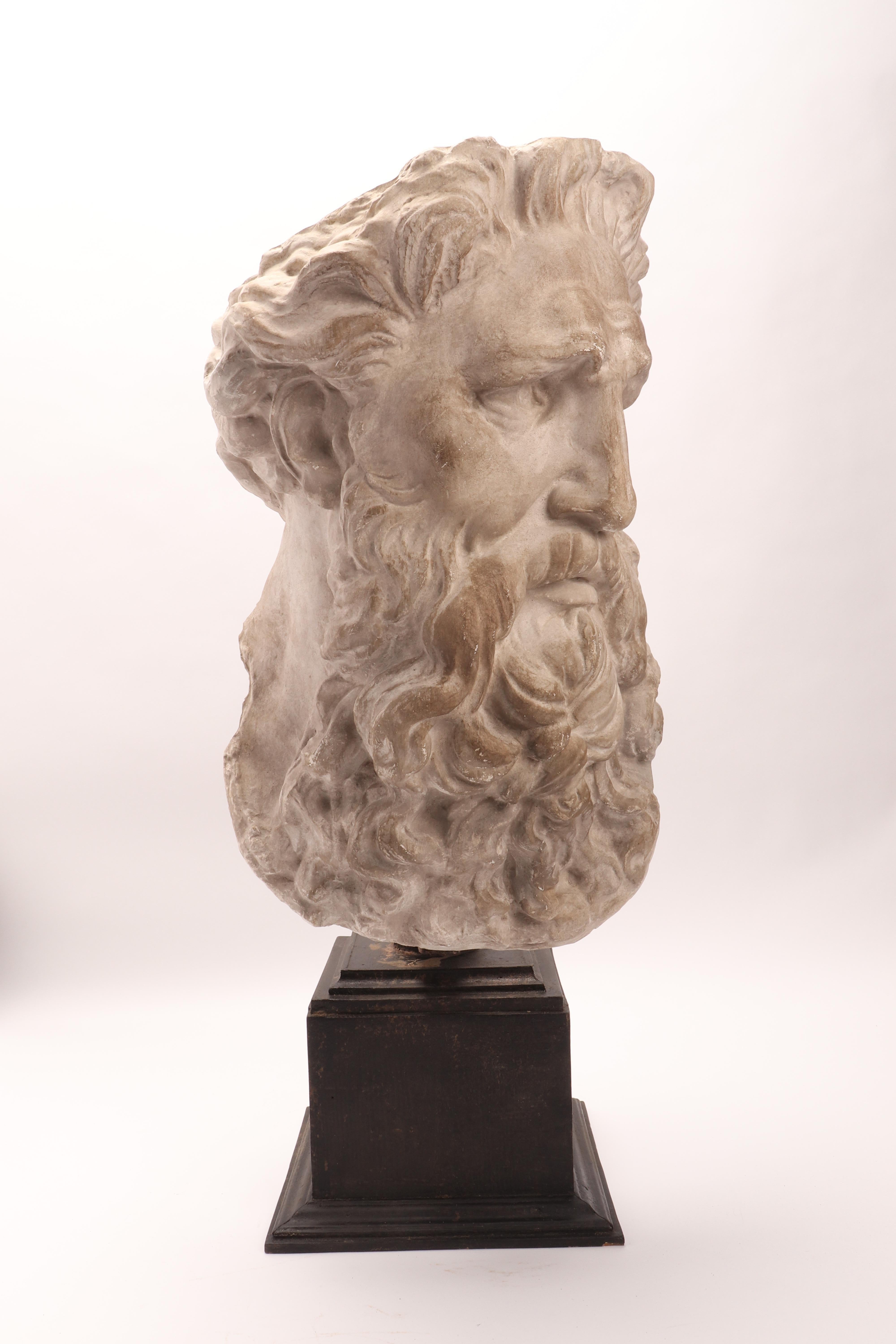 Over the wooden black painted base is set the plaster cast of the head of Neptune. The cast for drawing teaching in Academy. Italy, circa 1890.