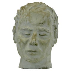 A plaster sculpture of a man's head with closed eyes - France - 1950