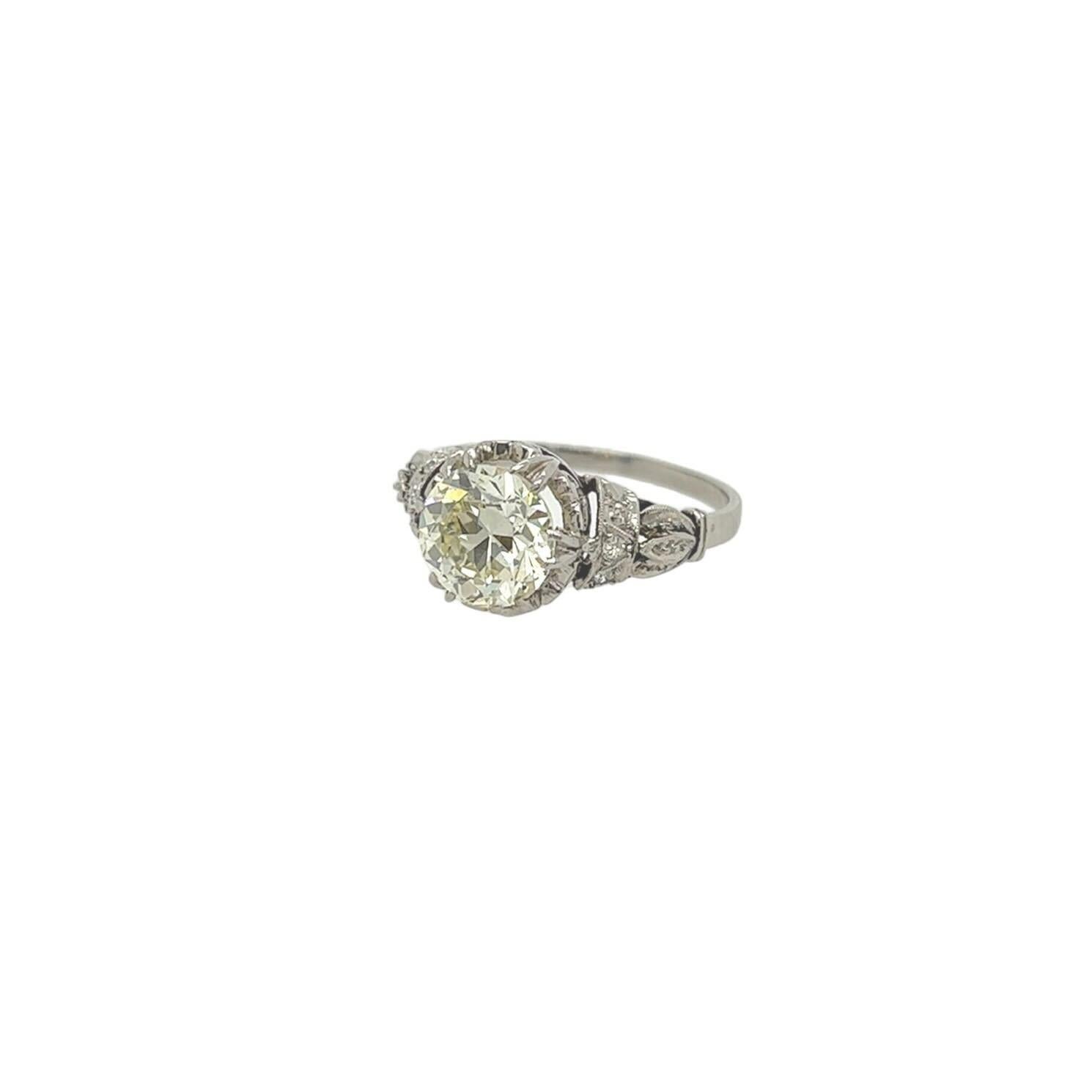 A platinum and diamond ring.  Centering an old European cut diamond of 1.75 carats* in a filigree setting with three (3) accent diamonds on each side.  Size approximately 6.  Gross weight approximately 3.70 grams.           
 *Stone removed and