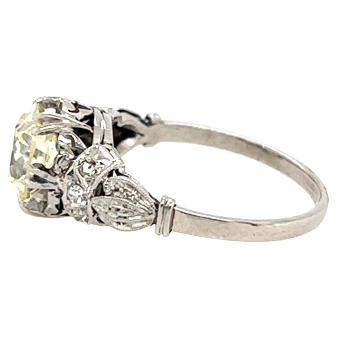 A platinum and diamond ring.  Centering an old European cut diamond of 1.75 carats* in a filigree setting with three (3) accent diamonds on each side.  Size approximately 6.  Gross weight approximately 3.70 grams.  *Stone removed and weighed