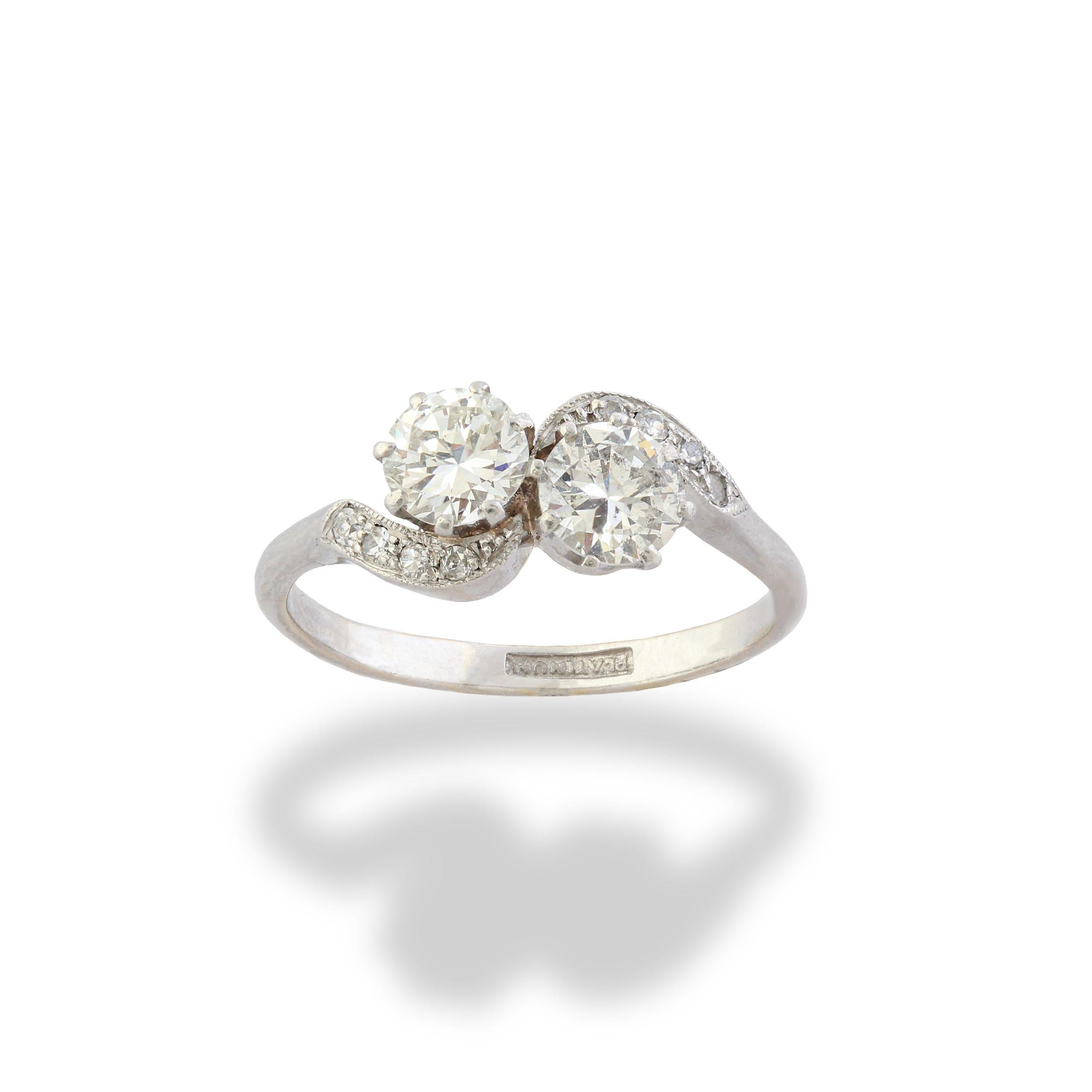 A platinum and diamond toi et moi ring. Toi et moi is French for you and me and the style symbolises the coming together of two people in love by two gemstones resting beside one another. The ring is claw-set with two circle-cut diamonds with