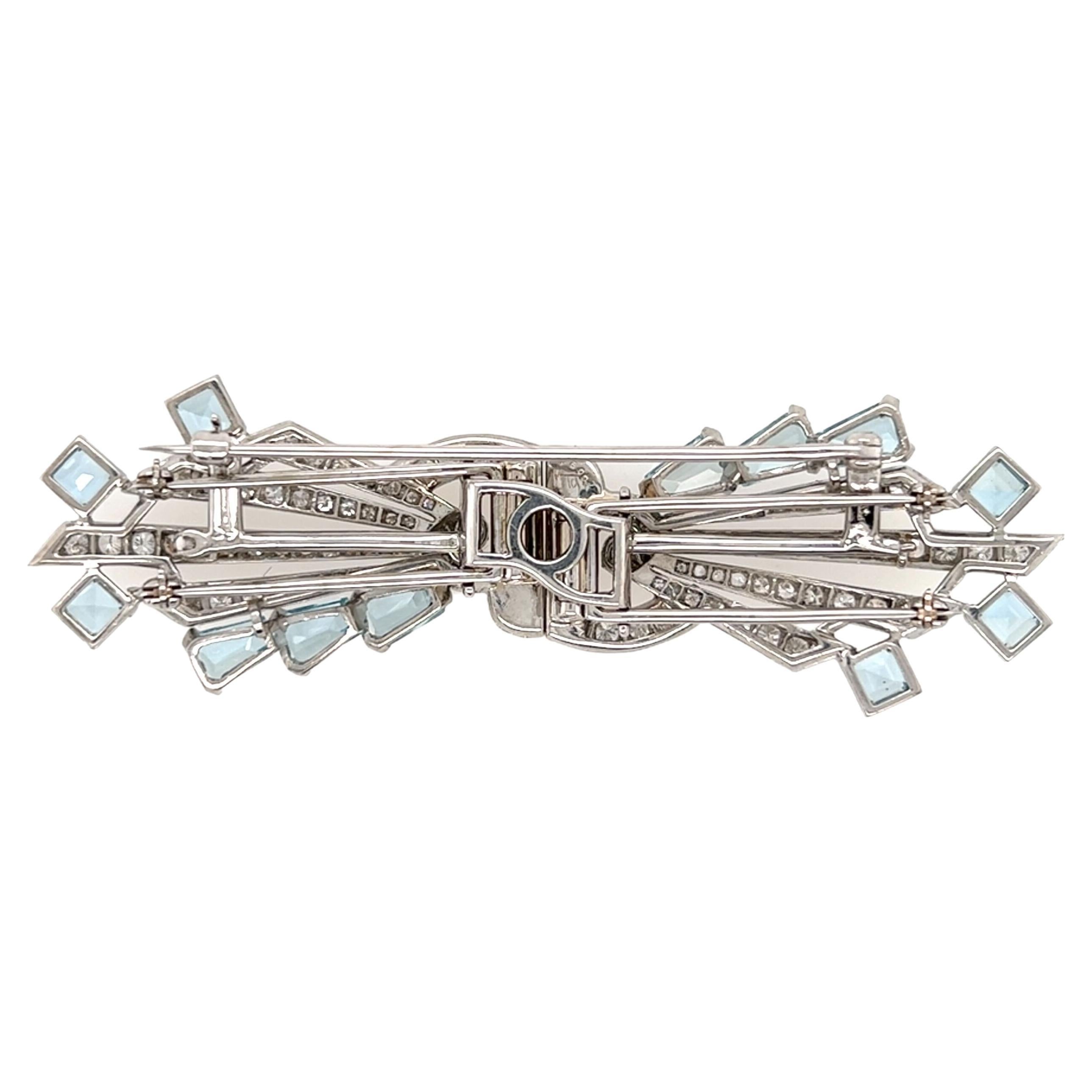 A platinum, aquamarine and diamond double clip brooch, 1940s.  Each side of the mirror image double clip brooch formed as four (4) rays emanating from a central bracket set with approximately fifty two (52) brilliant cut diamonds and two (2)