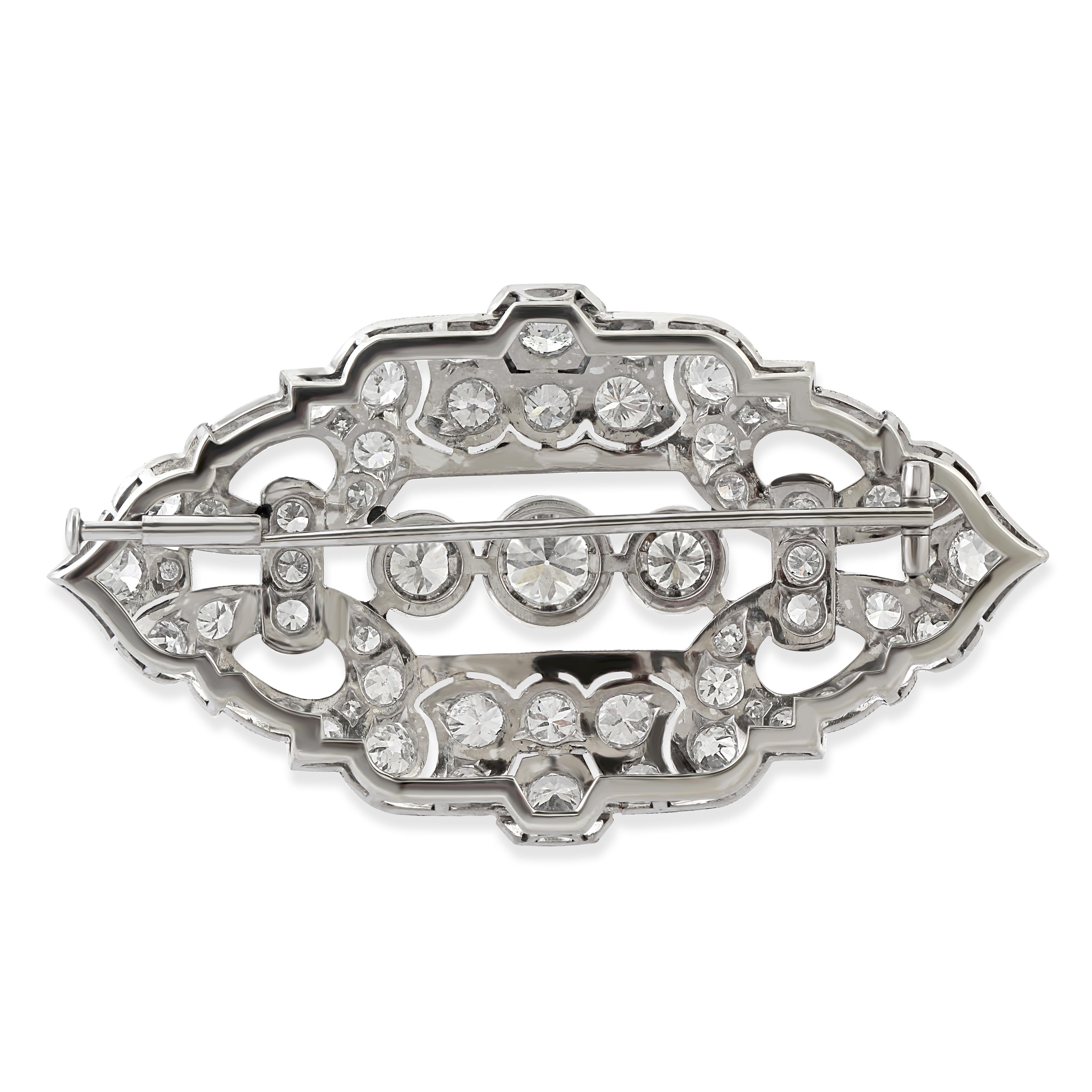 A 1920s openwork oval marquise shape diamond brooch set at the centre with three circle cut diamonds.
