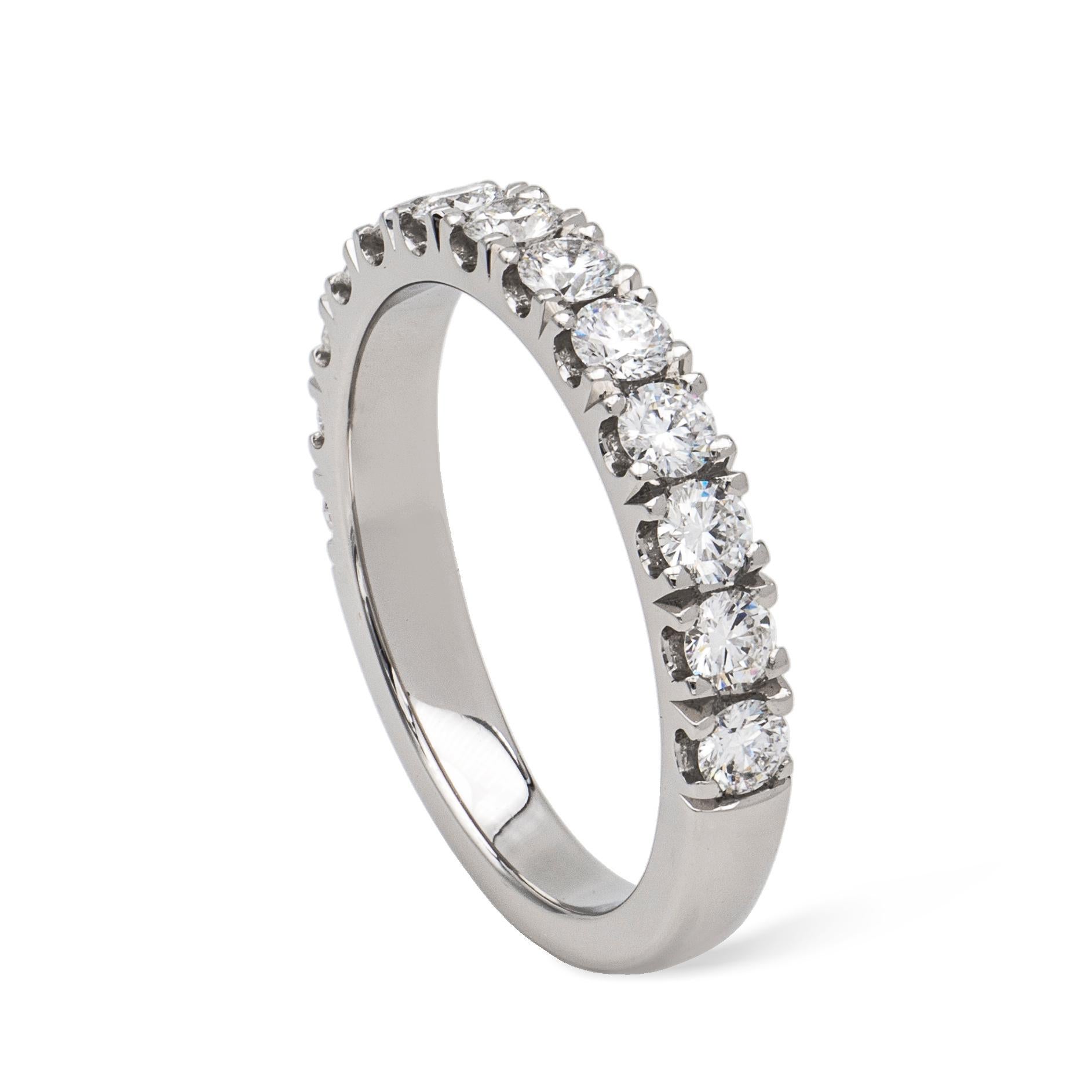 A platinum diamond half eternity ring, thirteen round brilliant cut diamond, total weight 0.79 carat, in castle claw settings on plain shank, hallmarked 950 platinum, London 2020, maker FEU, size K 1/2, gross weight 5.0grams.

This ring is
