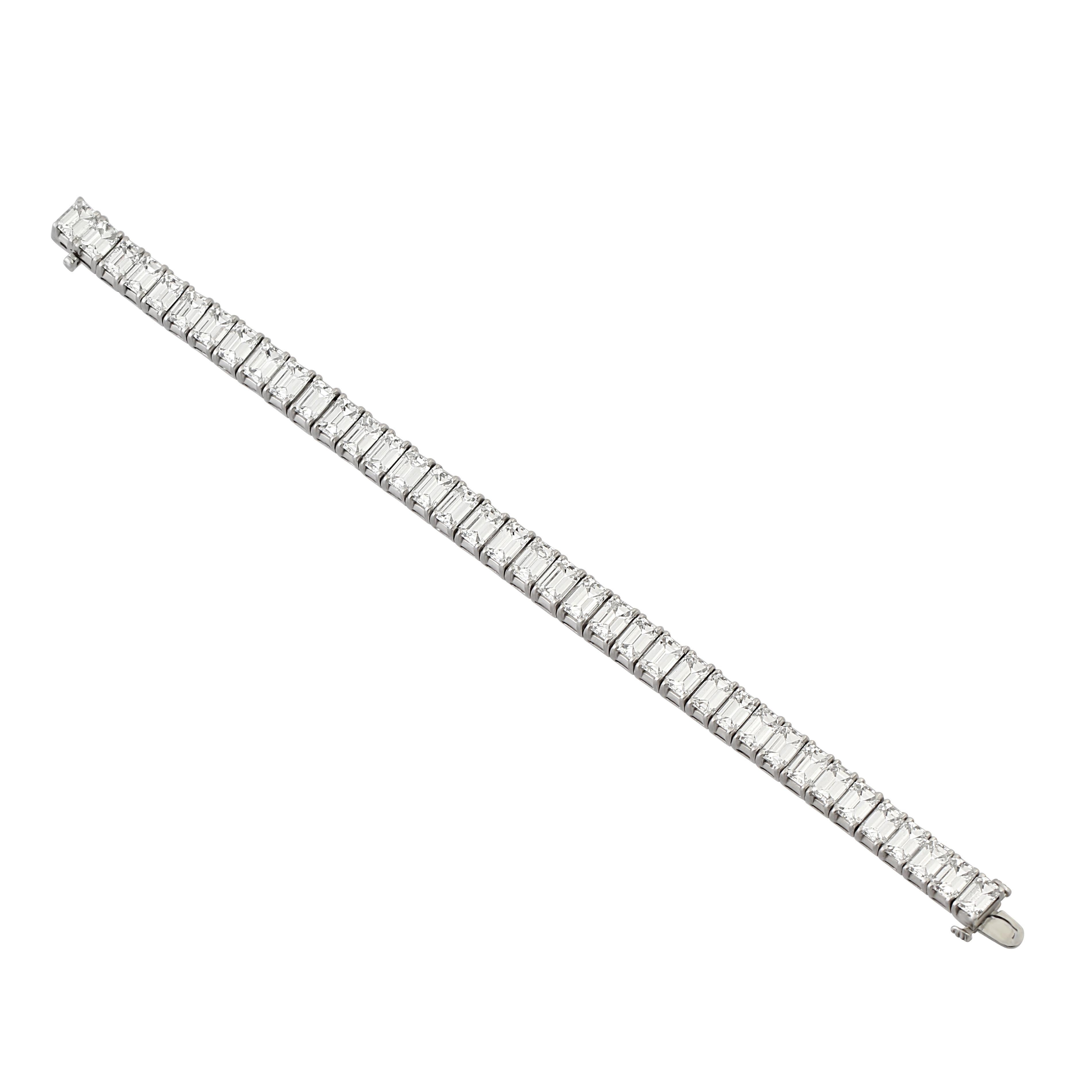A platinum and diamond line bracelet, set with 38 step-cut diamonds. Total diamond weight = 38.15 carats.

