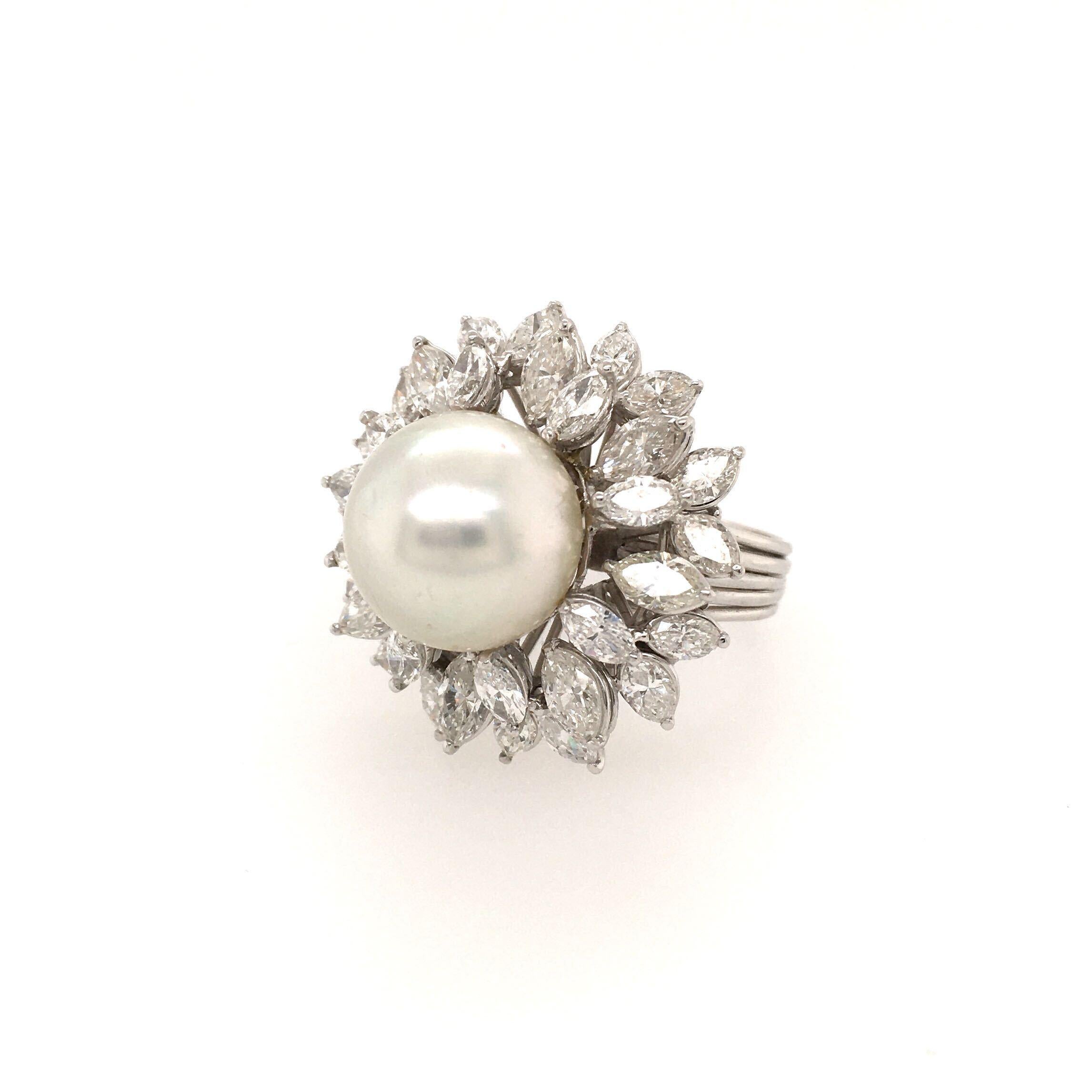 A platinum, South Sea pearl and diamond ring. Centering a white South Sea pearl, measuring approximately 13.20mm, within  marquise cut diamond cluster surround. Thirty two (32) diamonds weigh approximately 4.00 carats total. Size 7, gross weight is