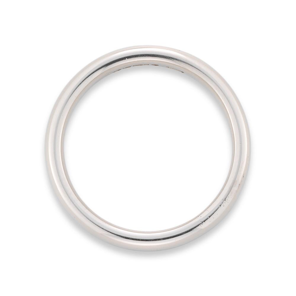 A platinum wedding band, the court shaped band measuring approximately 3.5 mm in width, hallmarked London, 2011, bearing the Bentley & Skinner sponsor mark, finger size L, 6.40 grams.

This ring is in perfect condition.

This simple and