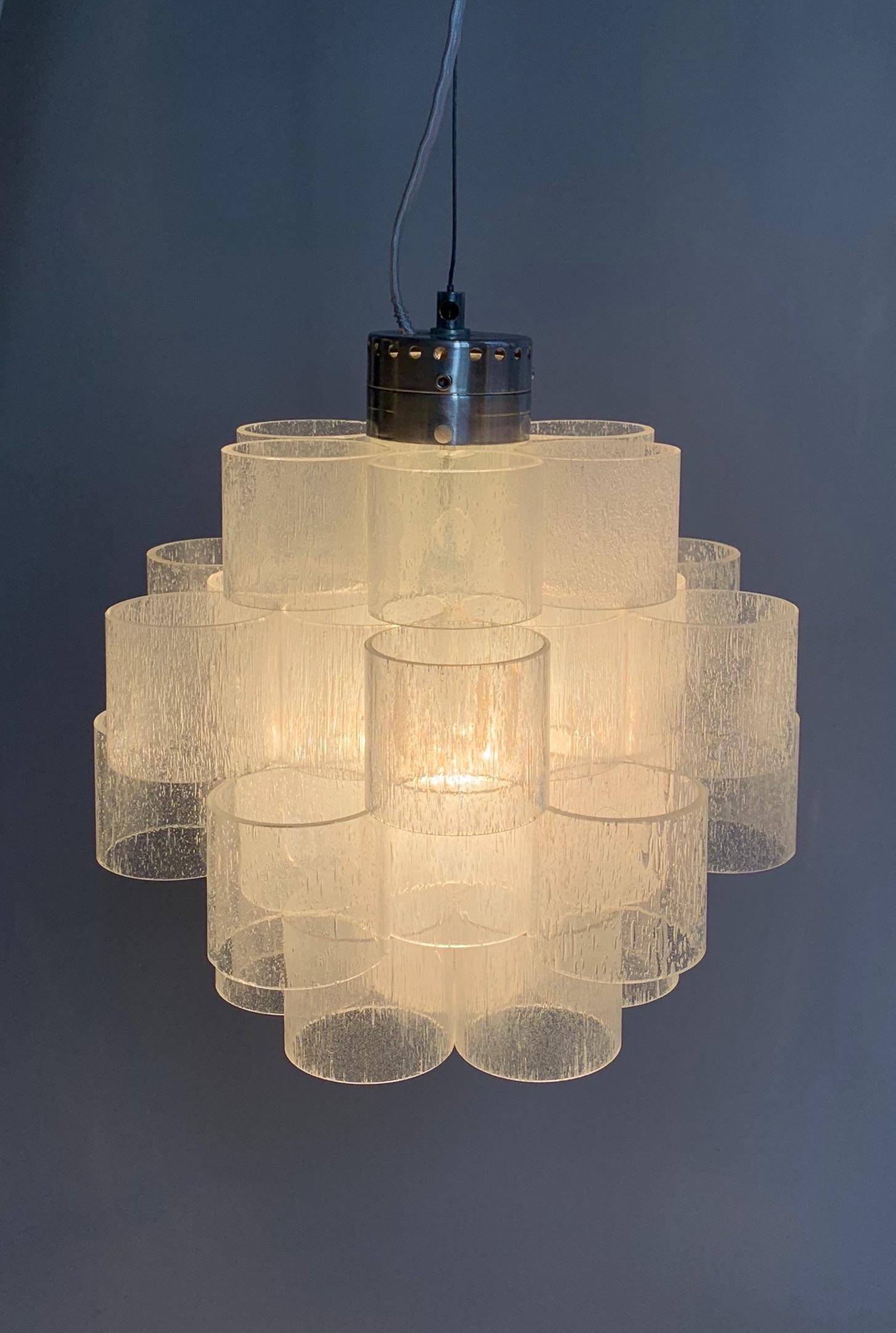 Chandelier composed of 36 cast glass cylinder components. With single 100watt lightbulb.